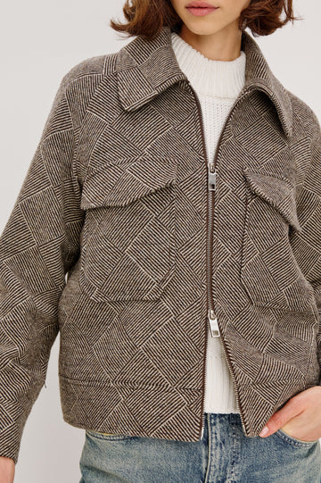 Truckee, a heavyweight wool-blend aviation-style jacket with a textured basketweave pattern. The jacket is fully lined and features oversized flap chest pockets and a two-way front zipper. Close Up View featured on model, Zipped Up