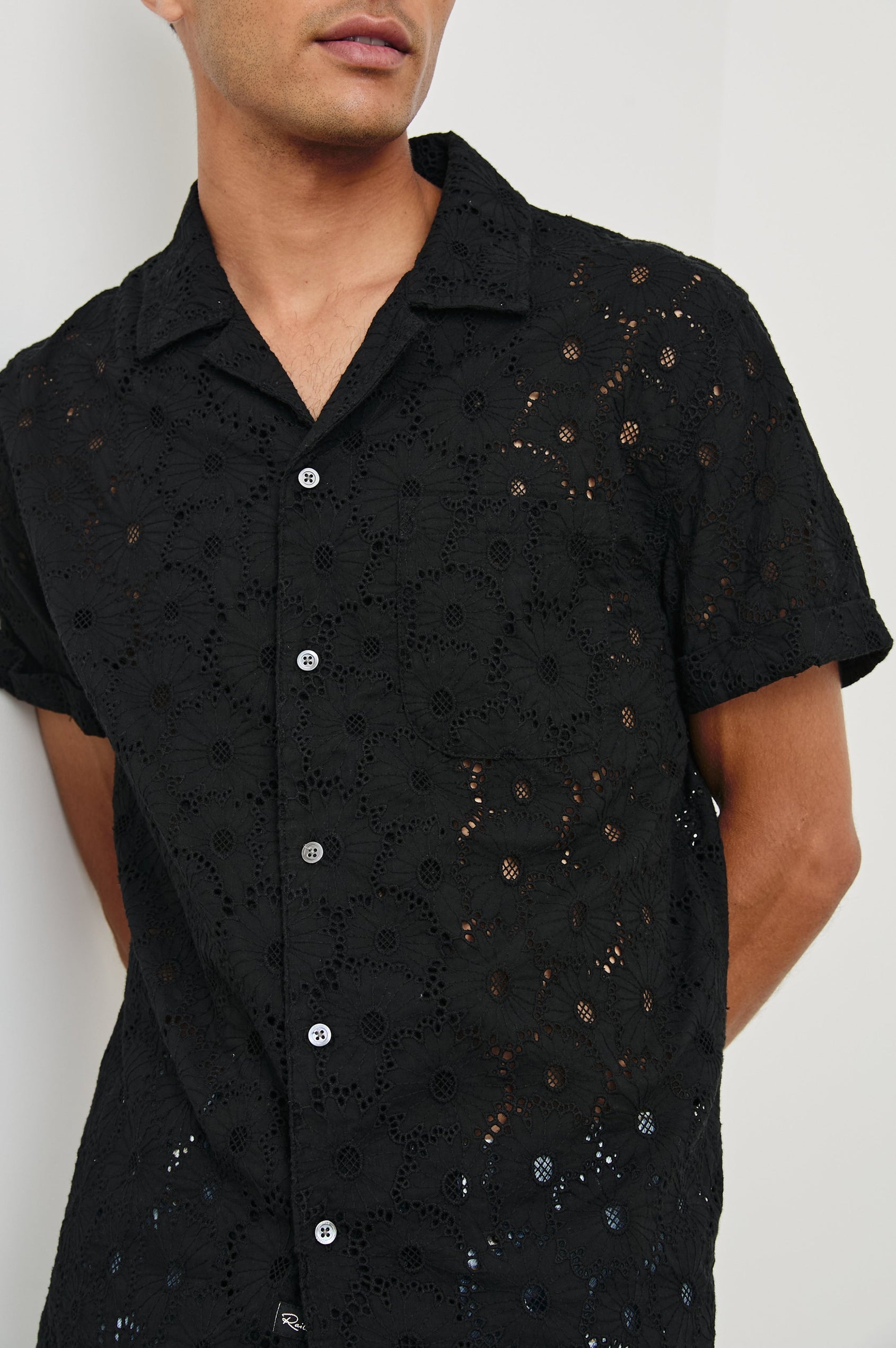 Tyler embroidered short sleeve button up with collar in Black Floral - close up of details on model