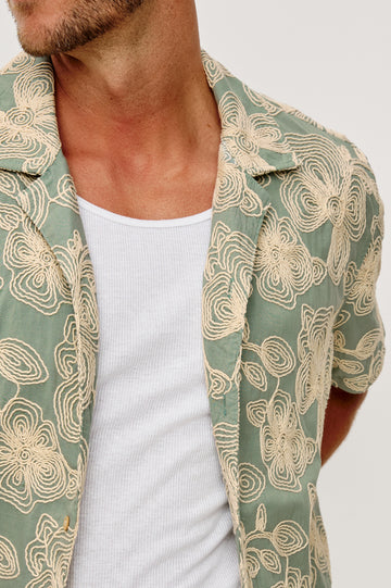 Tyler Shirt in Stretch Cotton With Floral Jute Embroidery, Front Buttons, Notched Collar, Short Sleeves, and Classic Fit in Floral Rope Jade Colorway - Upper Body Close Up Front View Featured on Model