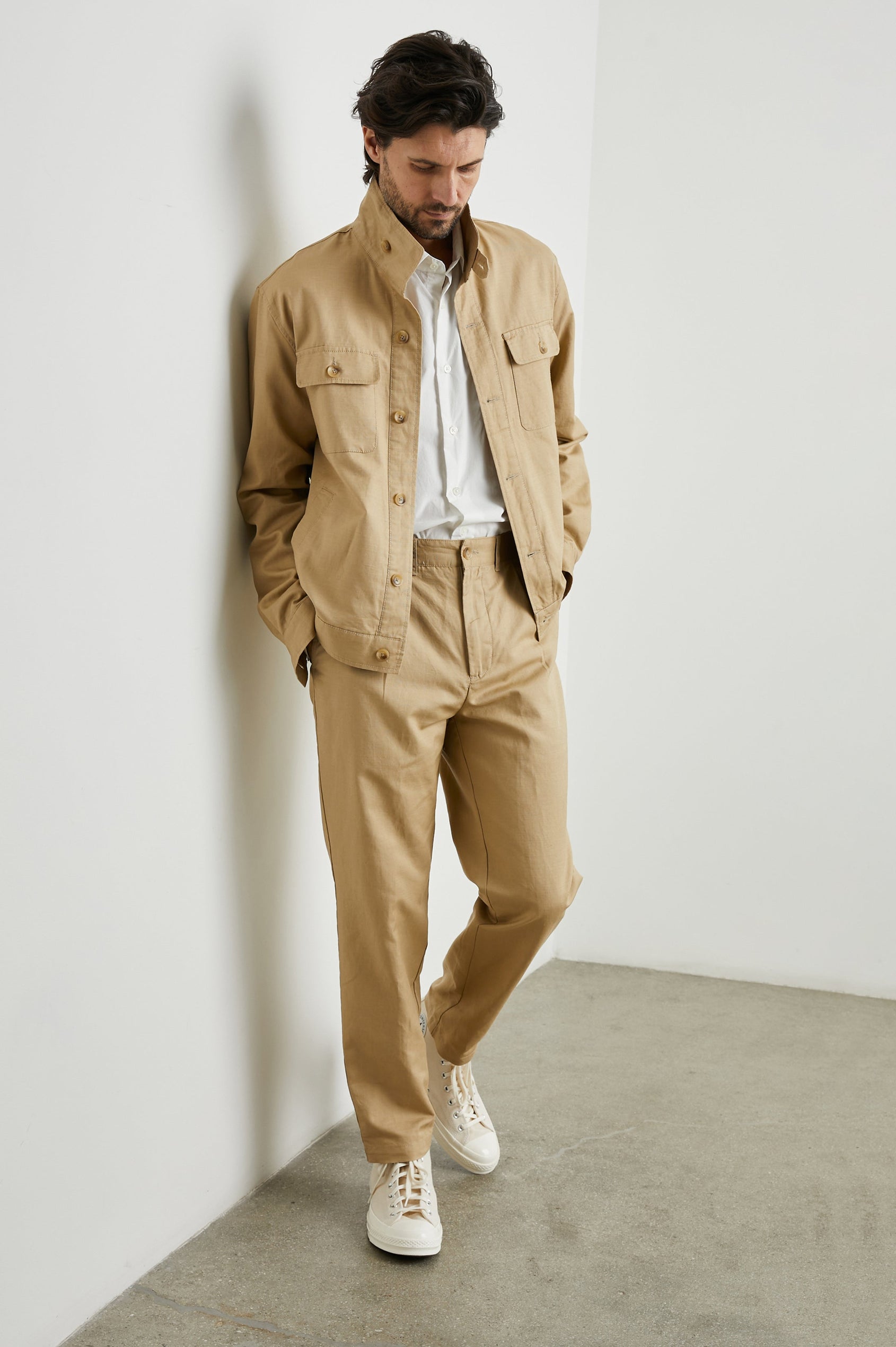 Tyrell Jacket with Button Closure, Two Front Pockets, Two Chest Buttoned Flap Pockets, and a Stand Collar in Khaki Colorway - Front Full Body View Featured on Model