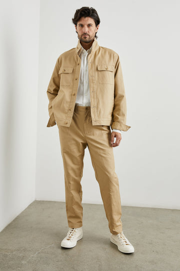 Tyrell Jacket with Button Closure, Two Front Pockets, Two Chest Buttoned Flap Pockets, and a Stand Collar in Khaki Colorway - Front Full Body View Featured on Model