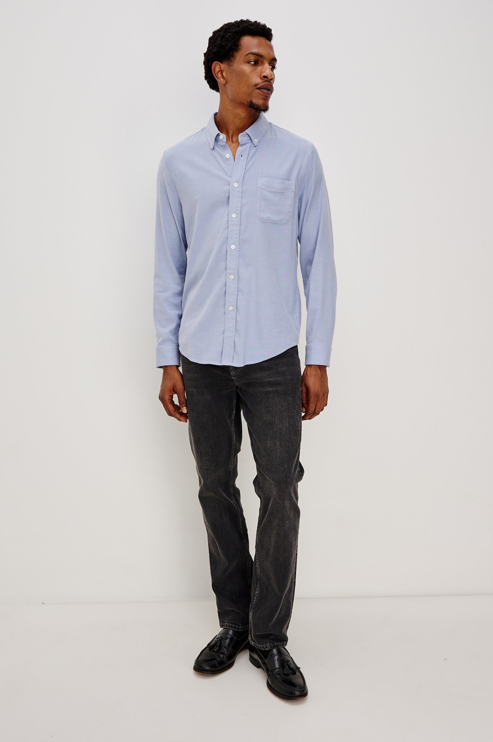Vance button front collared shirt with long sleeves, collard stand buttons and a single chest pocket in Blue Oxford colorway. Full body front view shown on model.