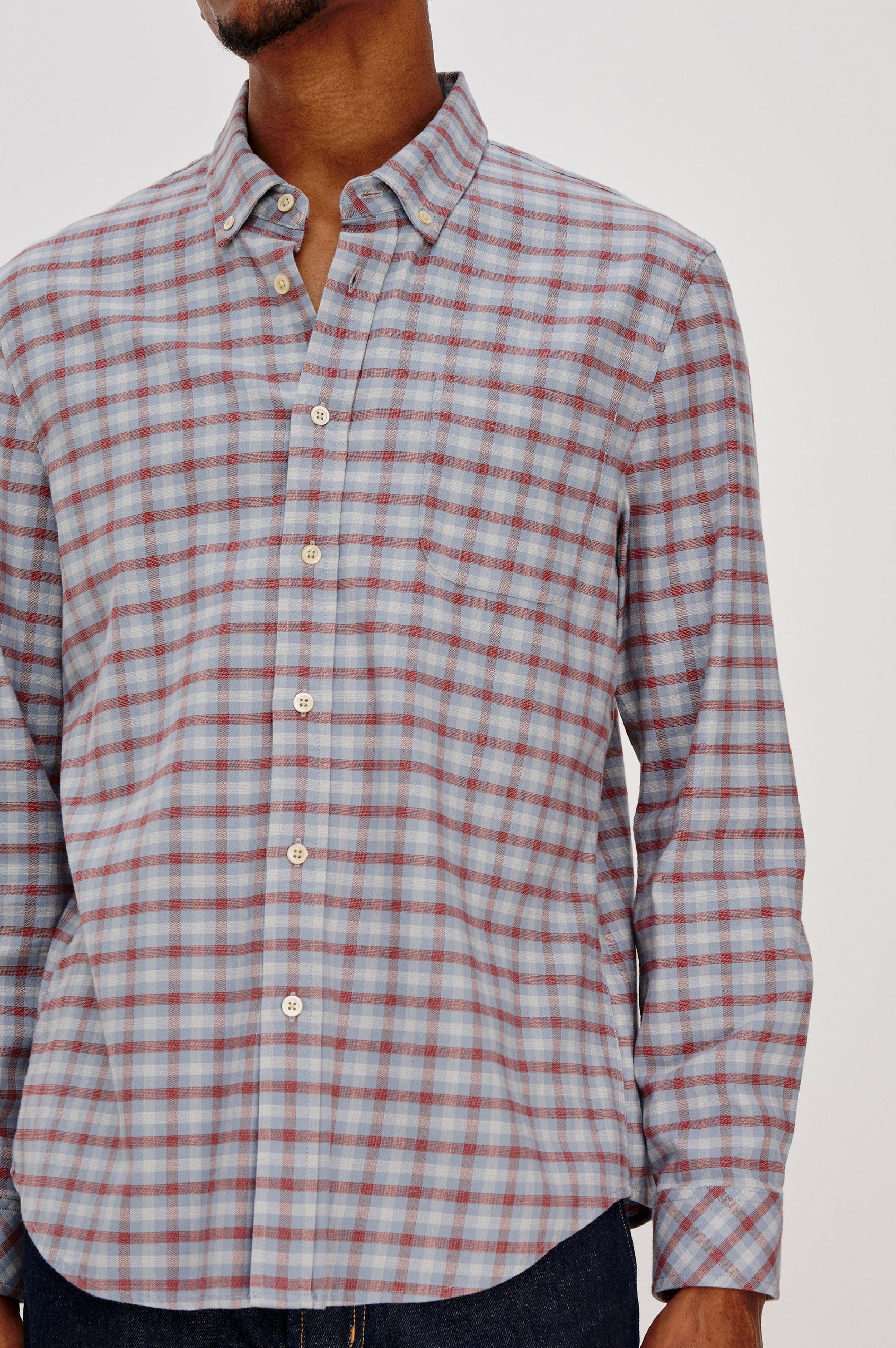 Vance button front collared shirt with long sleeves, collard stand buttons and a single chest pocket in Blue Ruby Check colorway. Front detail view featured on model.