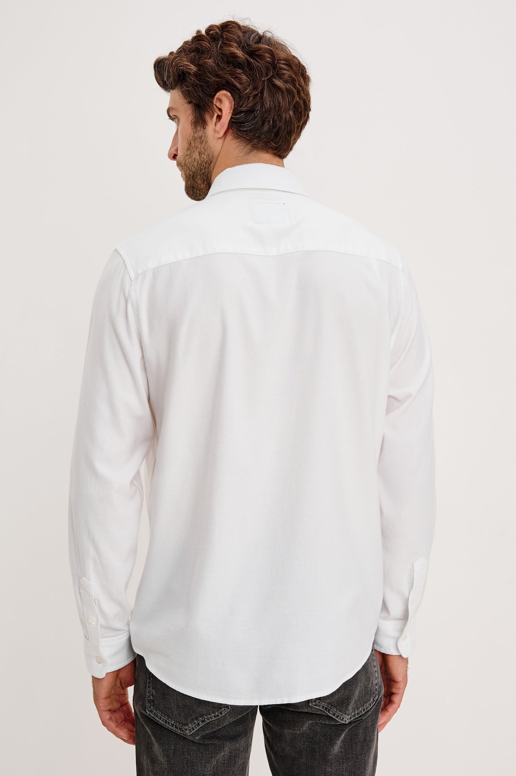 Vance button front collared shirt with long sleeves, collard stand buttons and a single chest pocket in White colorway. Back view featured on model.