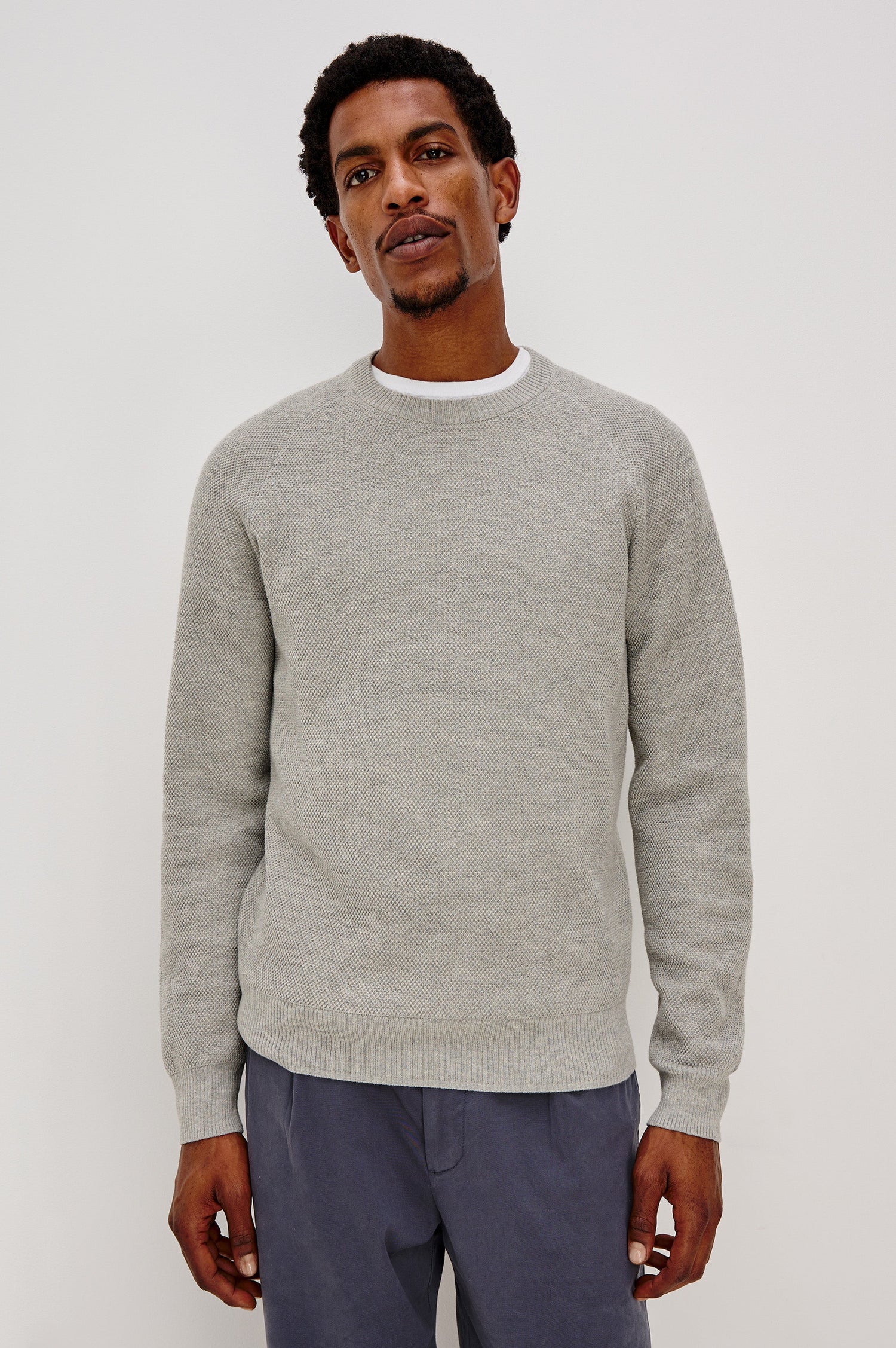 Vann long sleeve crew neck sweater in Grey Heather Colorway. Front View on Model Shown.