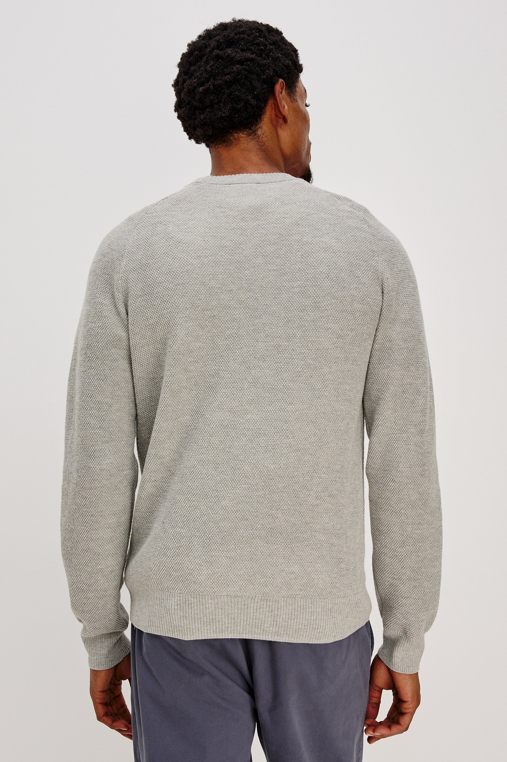 Vann long sleeve crew neck sweater in Grey Heather Colorway. Back View on Model Shown.
