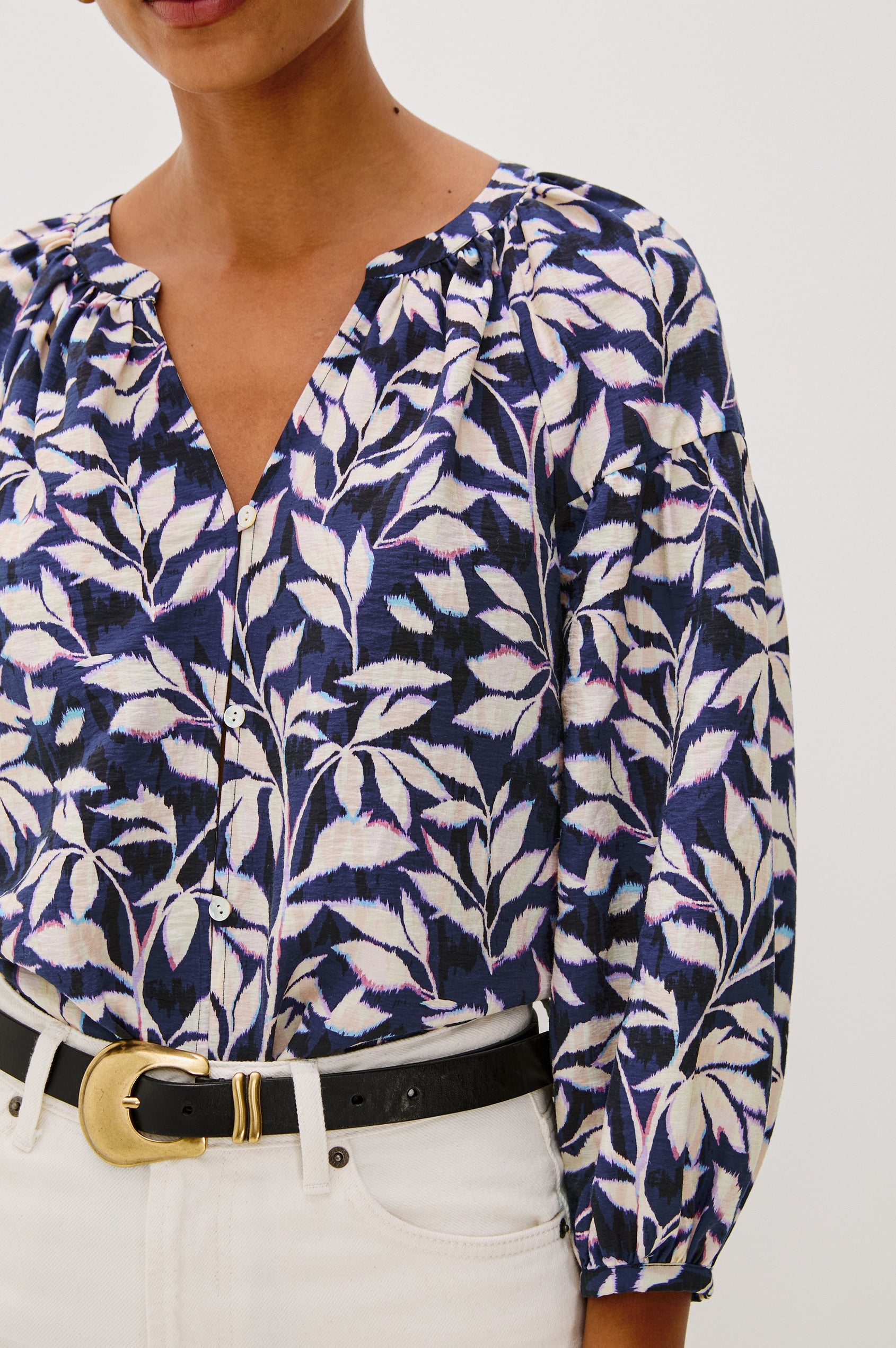 Vasia loose fitted long sleeve top with front button closure and raglan sleeves in Navy Vines print - close up of details on model