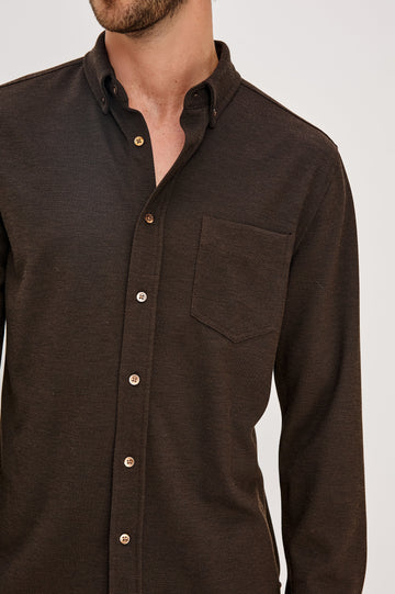 Vincent is a collared long sleeve button front shirt with a chest pocket in Espresso colorway. Front detail view featured on model.