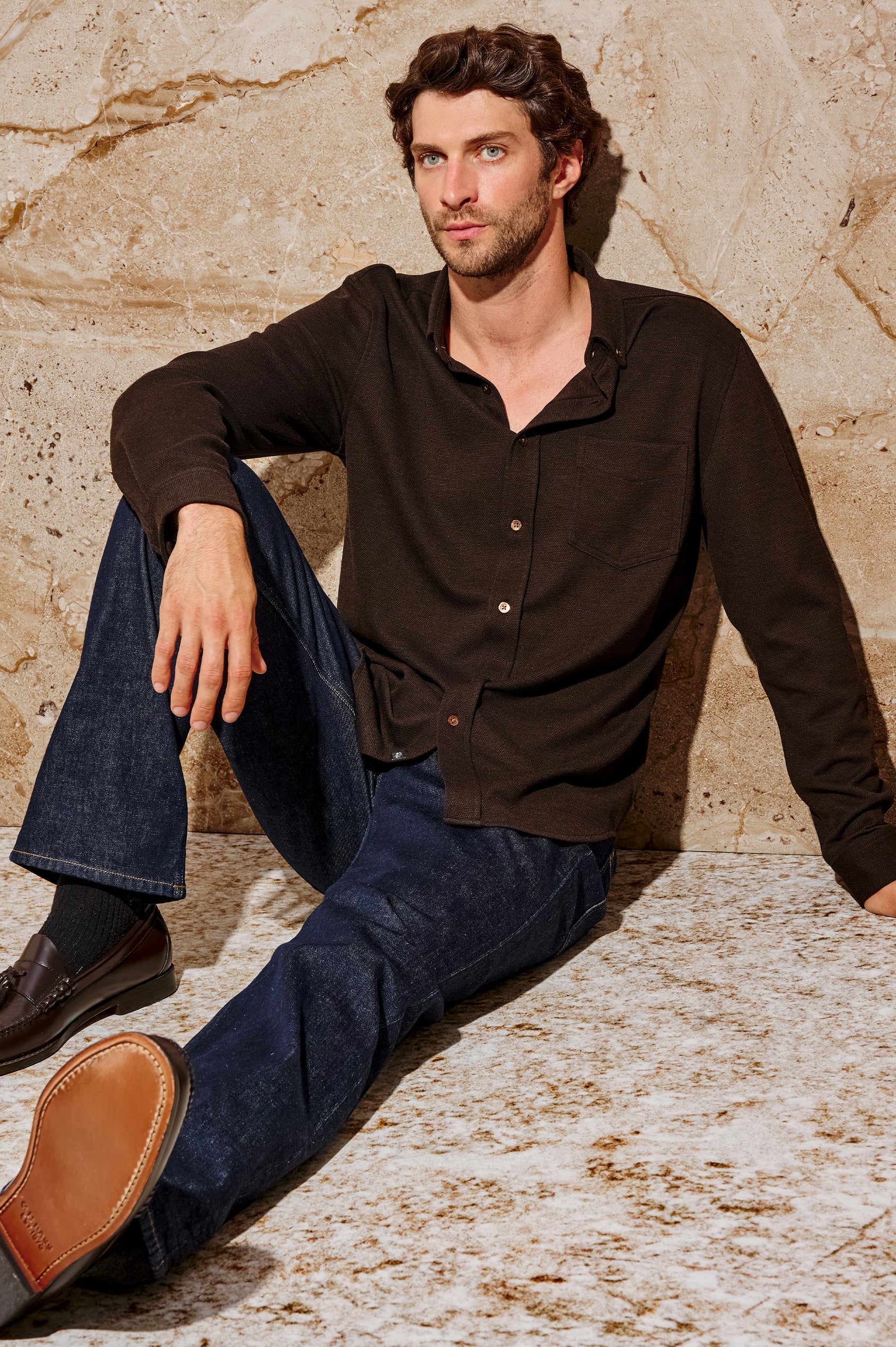 Vincent is a collared long sleeve button front shirt with a chest pocket in Espresso colorway. Front seated view featured on model.