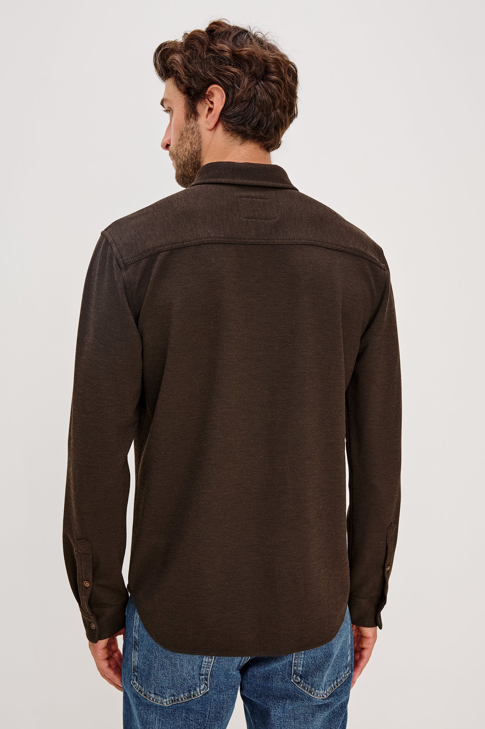 Vincent is a collared long sleeve button front shirt with a chest pocket in Espresso colorway. Back view featured on model.