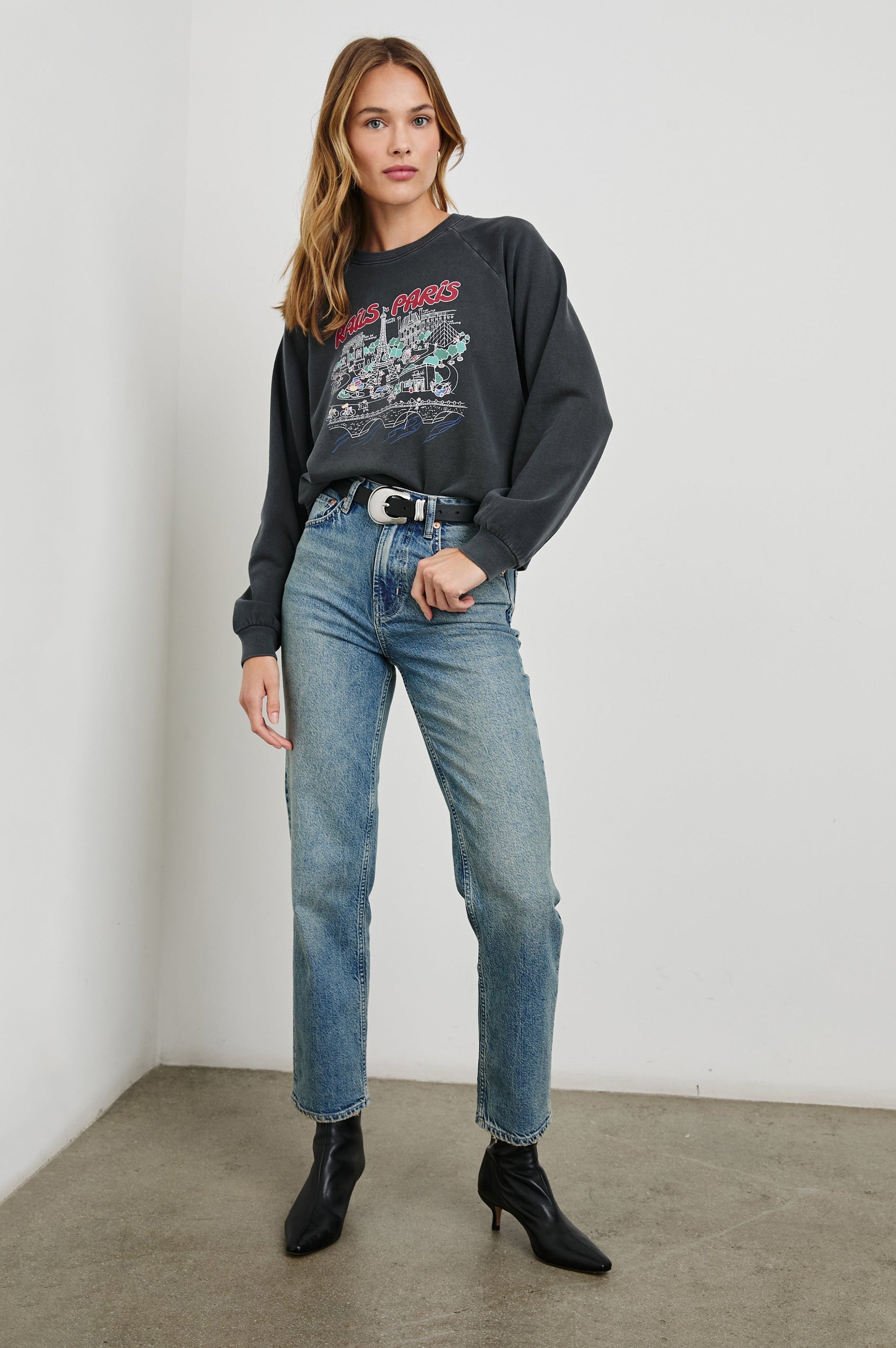 Vintage Raglan Long-Sleeve Sweatshirt with a Crew Neck, an image of landmarks in Paris and the Text, Rails Paris in Rails Paris Map Colorway, Mostly White and Green on Black - Front Full Body View Featured on Model