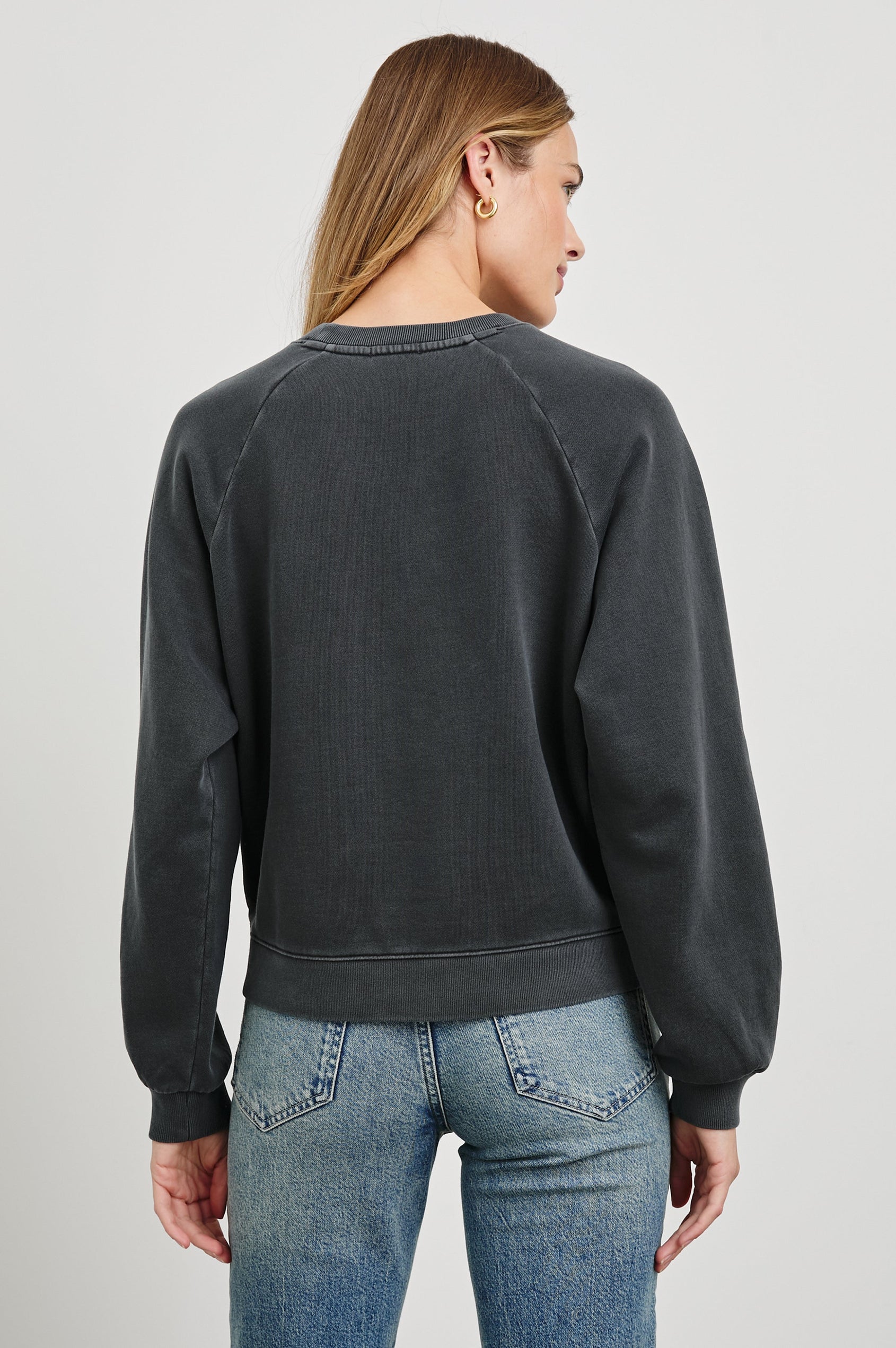 Vintage Raglan Long-Sleeve Sweatshirt with a Crew Neck, an image of landmarks in Paris and the Text, Rails Paris in Rails Paris Map Colorway, Mostly White and Green on Black - Back View Featured on Model