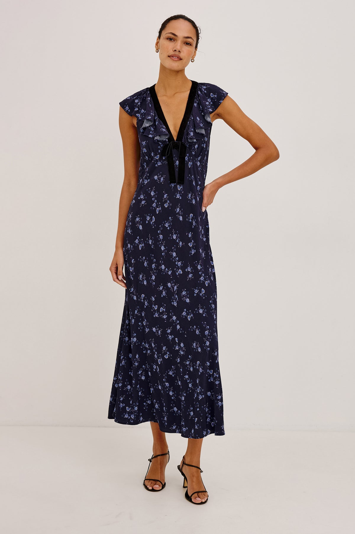 Virginia Maxi Dress in Lightweight Crepe With Ruffle-Trimmed Plunging V-Neckline With Center-Front Bow, Bias Cut, Side Zip Closure, and Godet Insets in Navy Romantic Floral Colorway - Front View Featured on Model.