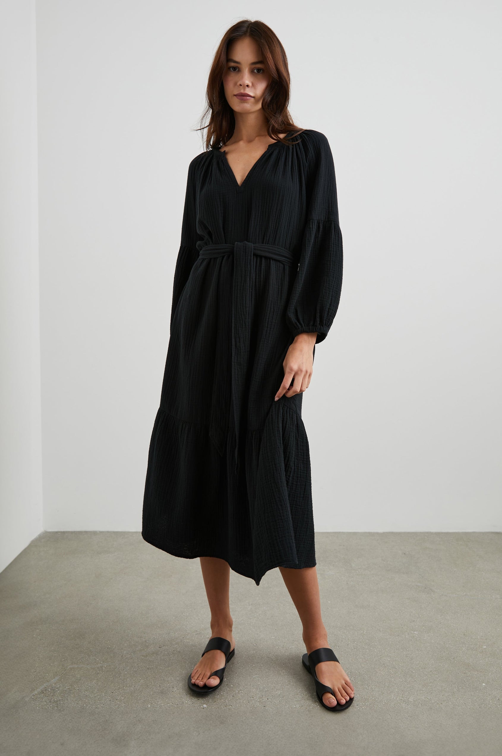 Vittoria Midi Dress with Three-Quarter Sleeves, a V Neck, Light Ruching at the Collar, and a Fabric Tie Belt in Black Colorway - Front Full Body View Featured on Model