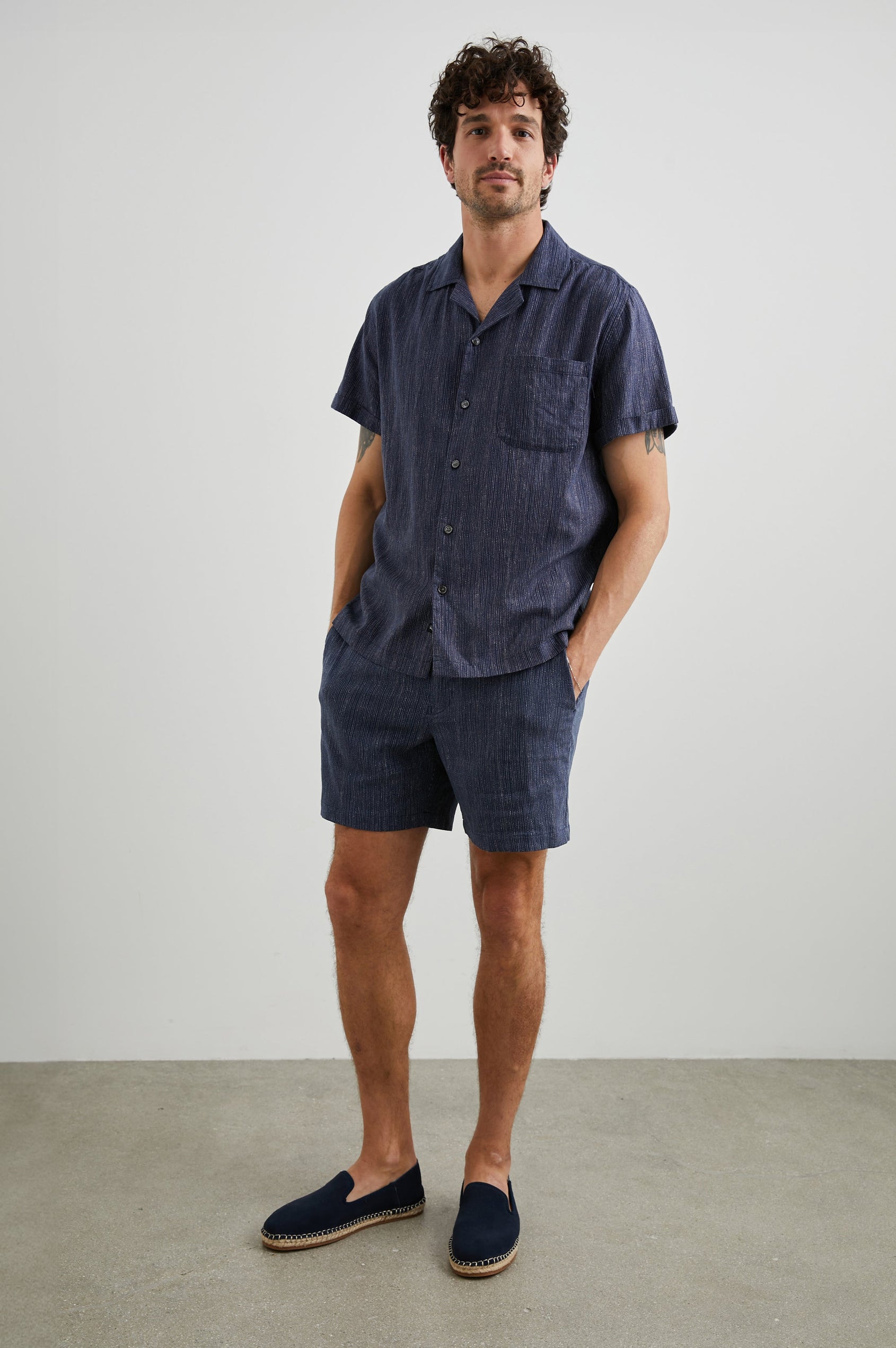 Waimea Short-Sleeve Button Up with a Chest Patch Pocket in Matrix Navy Pearl Colorway, with thin pearl vertical dashes on navy - Front Full Body View Featured on Model