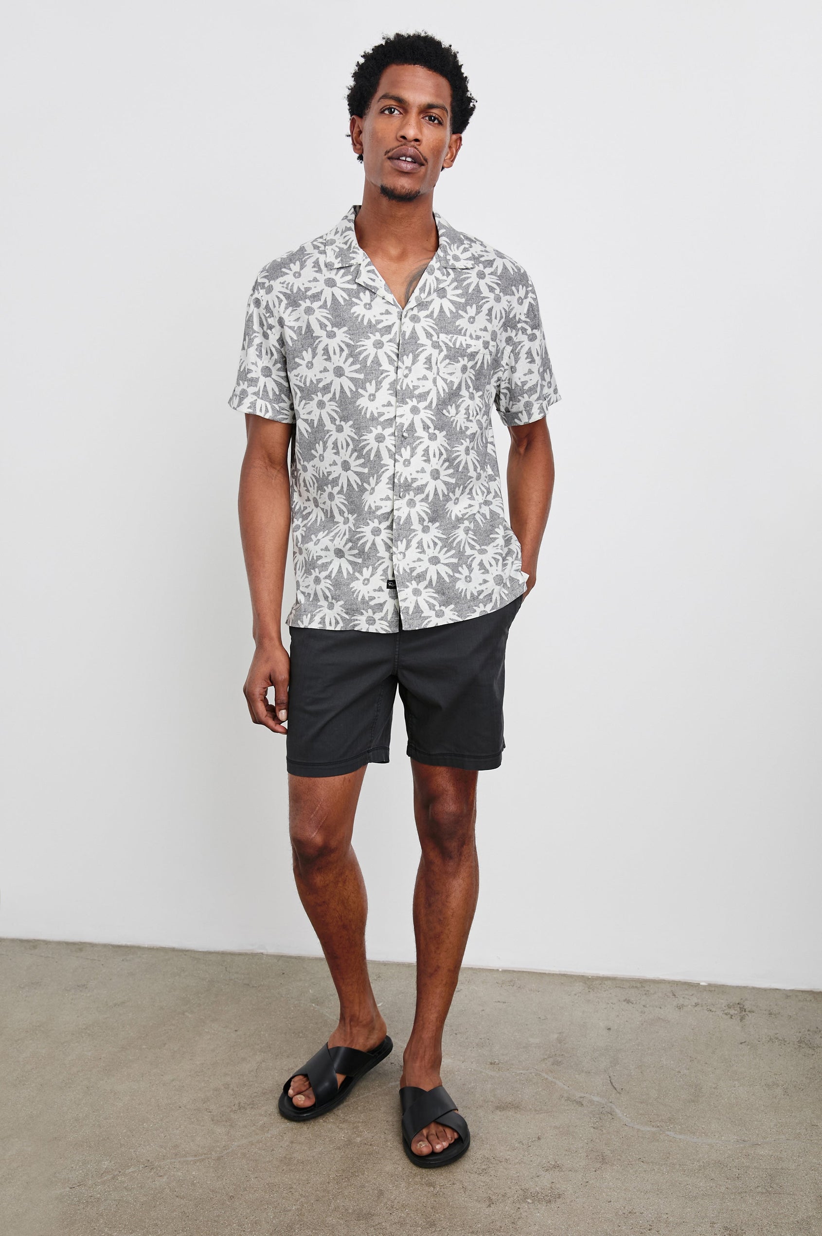 Waimea short sleeve button down shirt with camp collar and floral pattern details in Perennial Charcoal White - full body front view on model