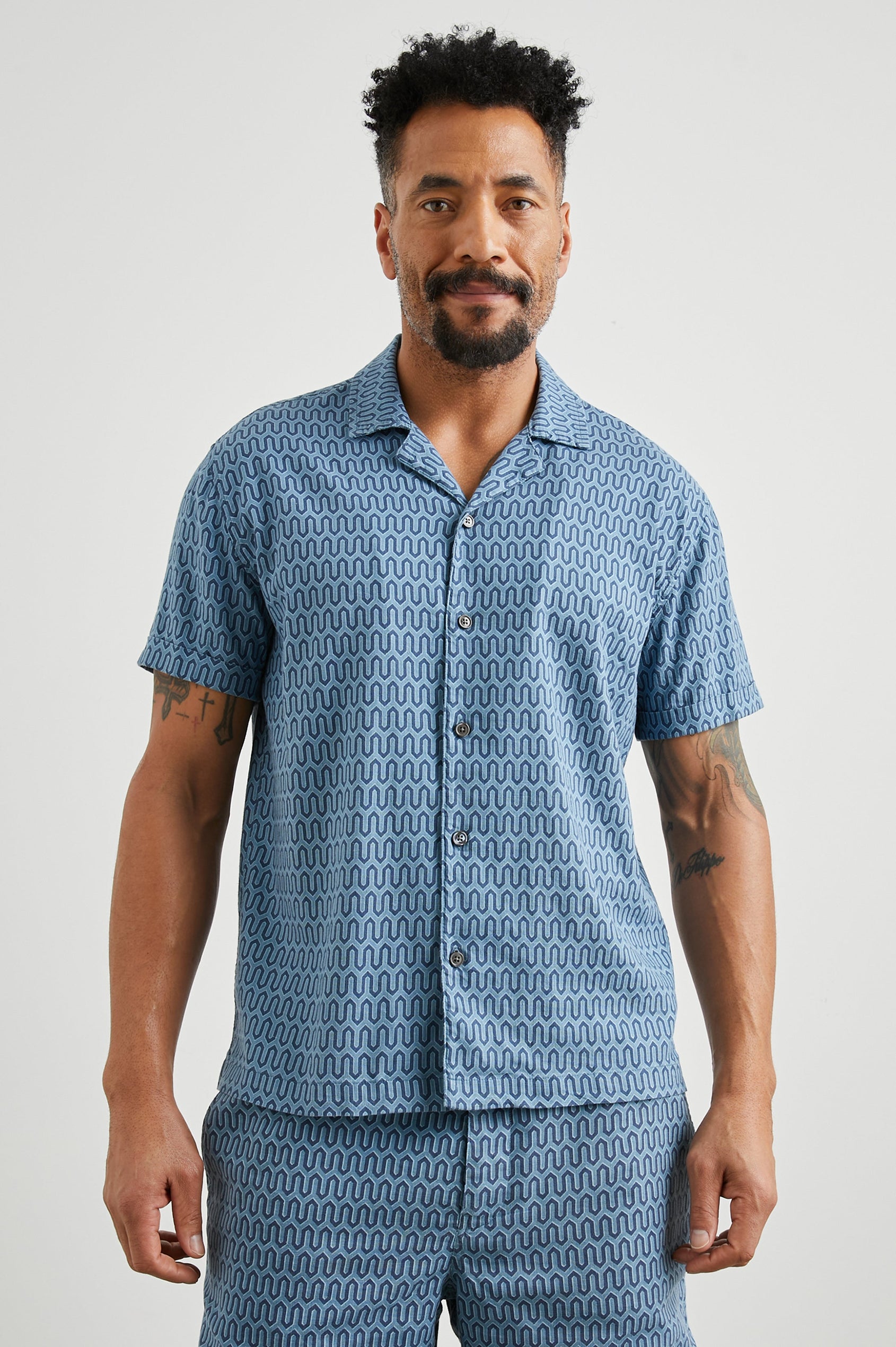 Waimea Short-Sleeve Button Up with a Chest Patch Pocket in Wishbone Blues Colorway, a dark and light blue geometric pattern - Front View Featured on Model