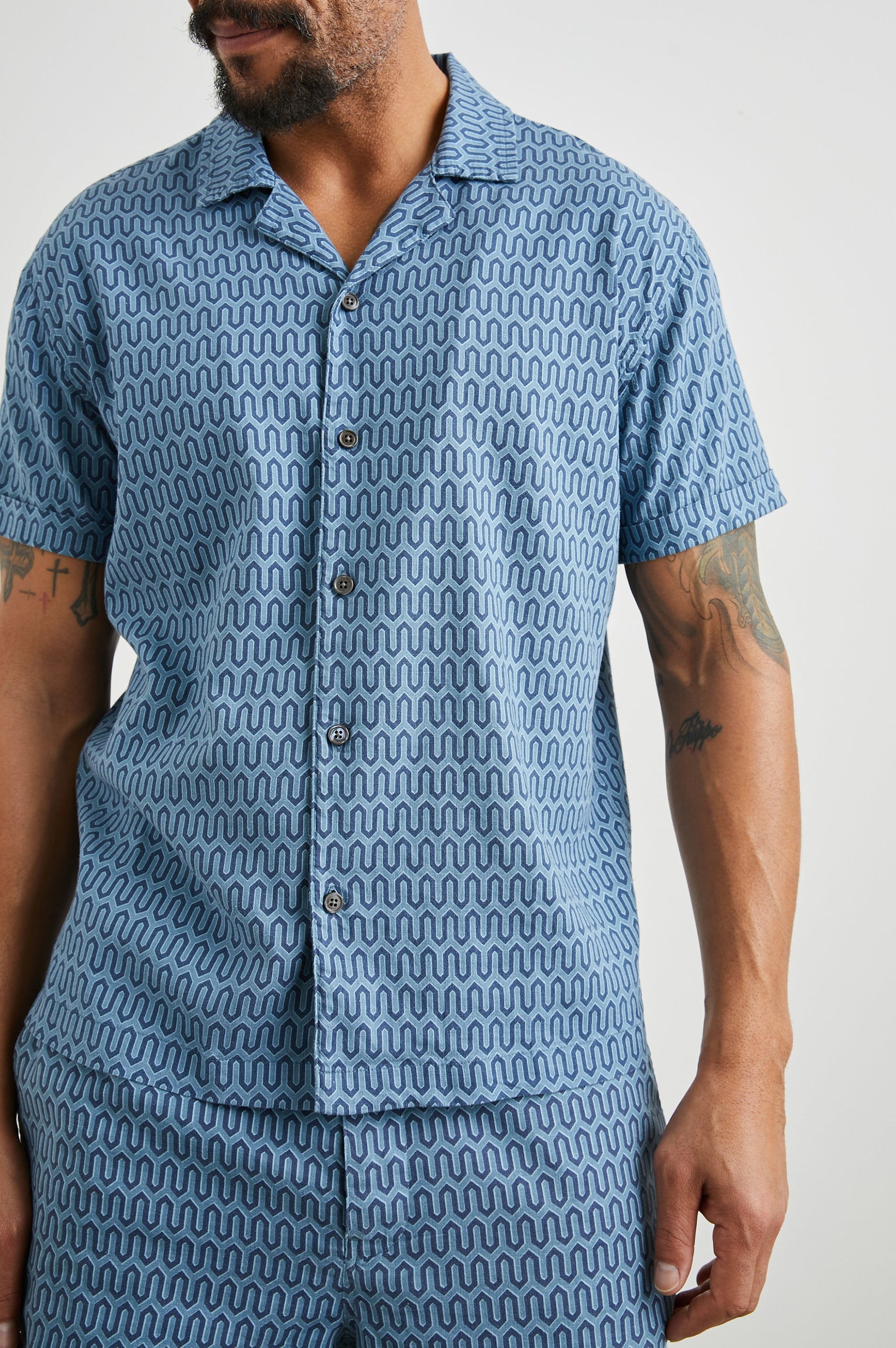 Waimea Short-Sleeve Button Up with a Chest Patch Pocket in Wishbone Blues Colorway, a dark and light blue geometric pattern - Front View Featured on Model
