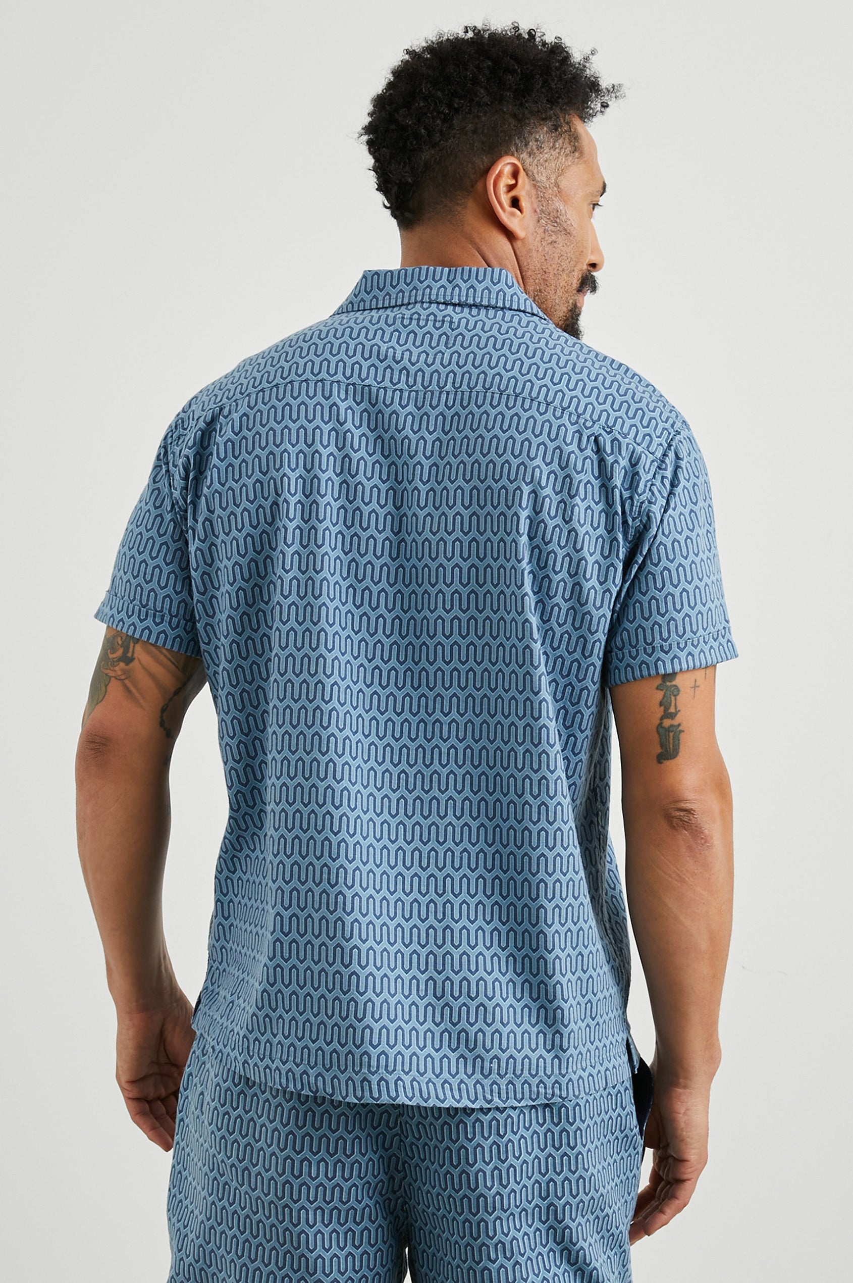 Waimea Short-Sleeve Button Up with a Chest Patch Pocket in Wishbone Blues Colorway, a dark and light blue geometric pattern - Back View Featured on Model