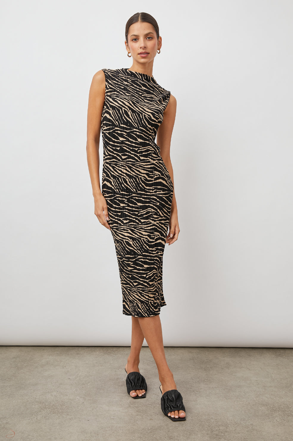 Wakely Sleeveless Midi Dress with Pleated Fabric and a Mock Neck in Cairo Colorway, a Black and Tan Tiger Print - Front Full Body View Featured on Model 