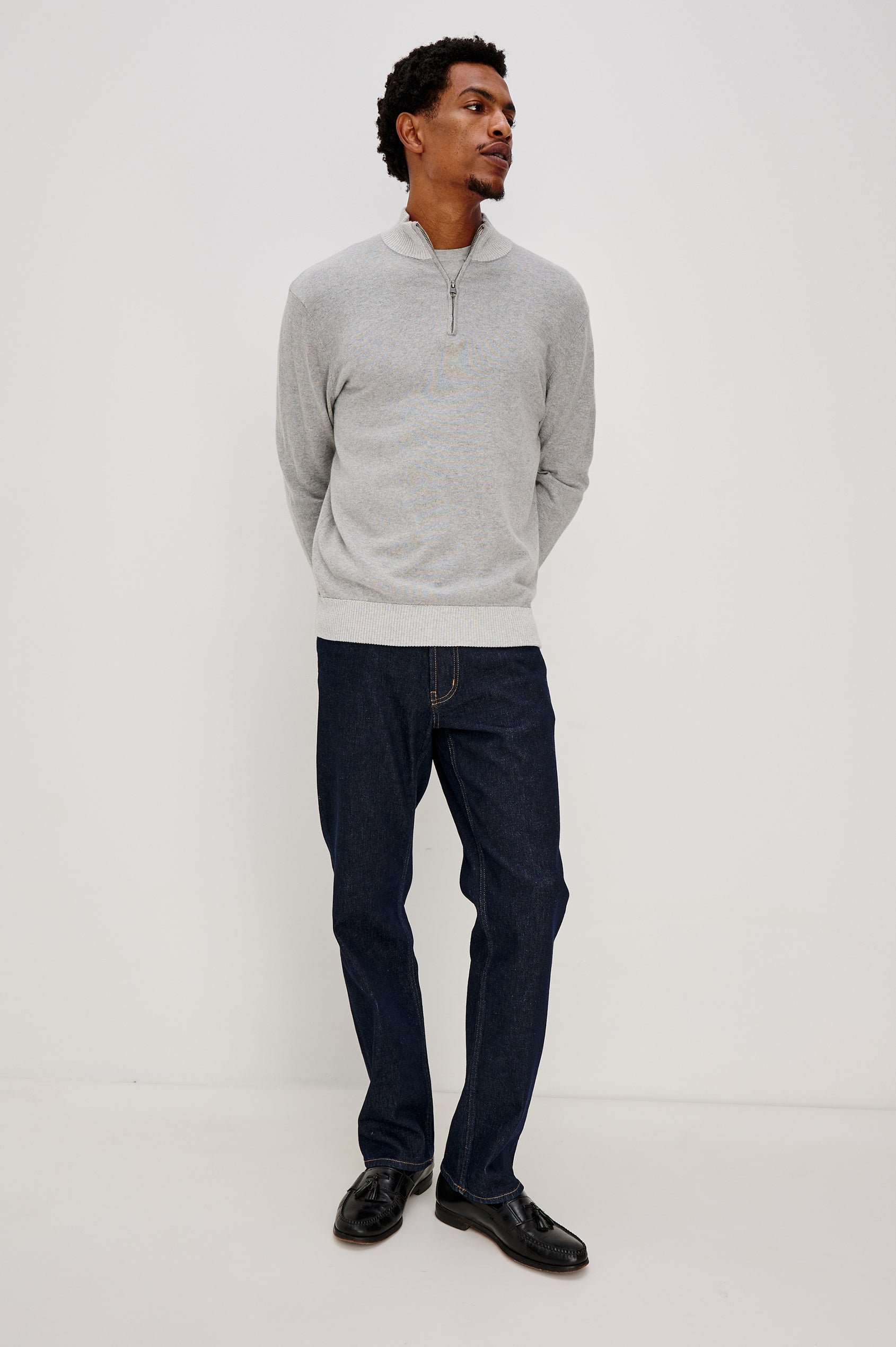 The Waylon is a quarter zip mock neck sweater with long sleeves and rib trim in Grey Heather colorway. Front full body view featured on model.