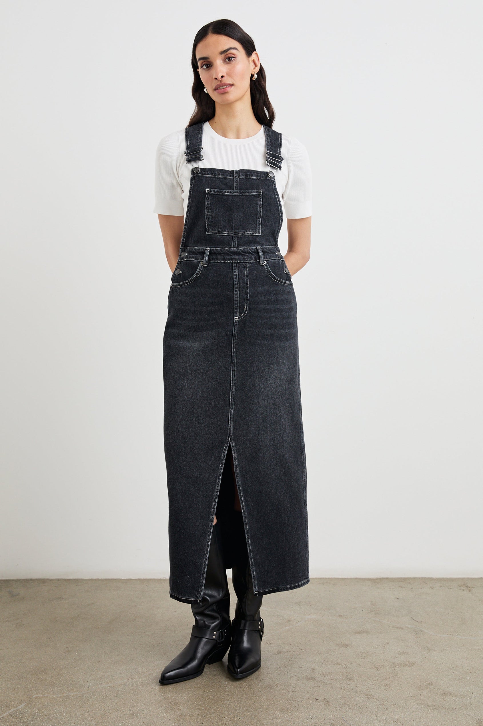 Westlake Midi Denim Dress with an Overalls-Style Bodice, Two Front Pockets, a Bib Chest Patch Pocket, Two Back Patch Pockets, Belt Loops and a Center Slit in Black Sand Colorway - Front Full Body View Featured on Model