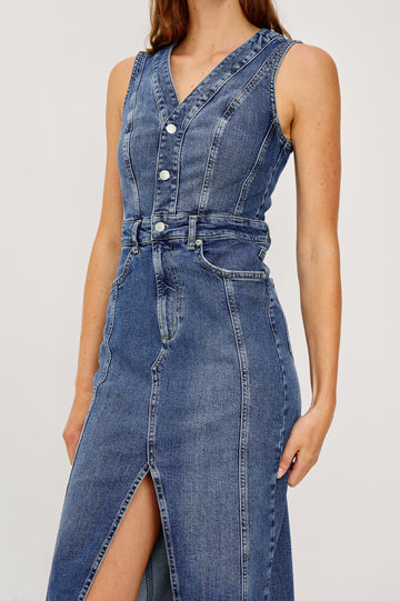 Westwood Sleeveless Denim Midi Dress with Belt Loops, a Button and Zipper Closure for the Skirt and Button Closure on the Bodice, a V neck, a Front Center Thigh Slit, Two Front Pockets  and Two Back Patch Pockets in Forget Me Not Colorway, a Blue - Close Up Front View Featured on Model