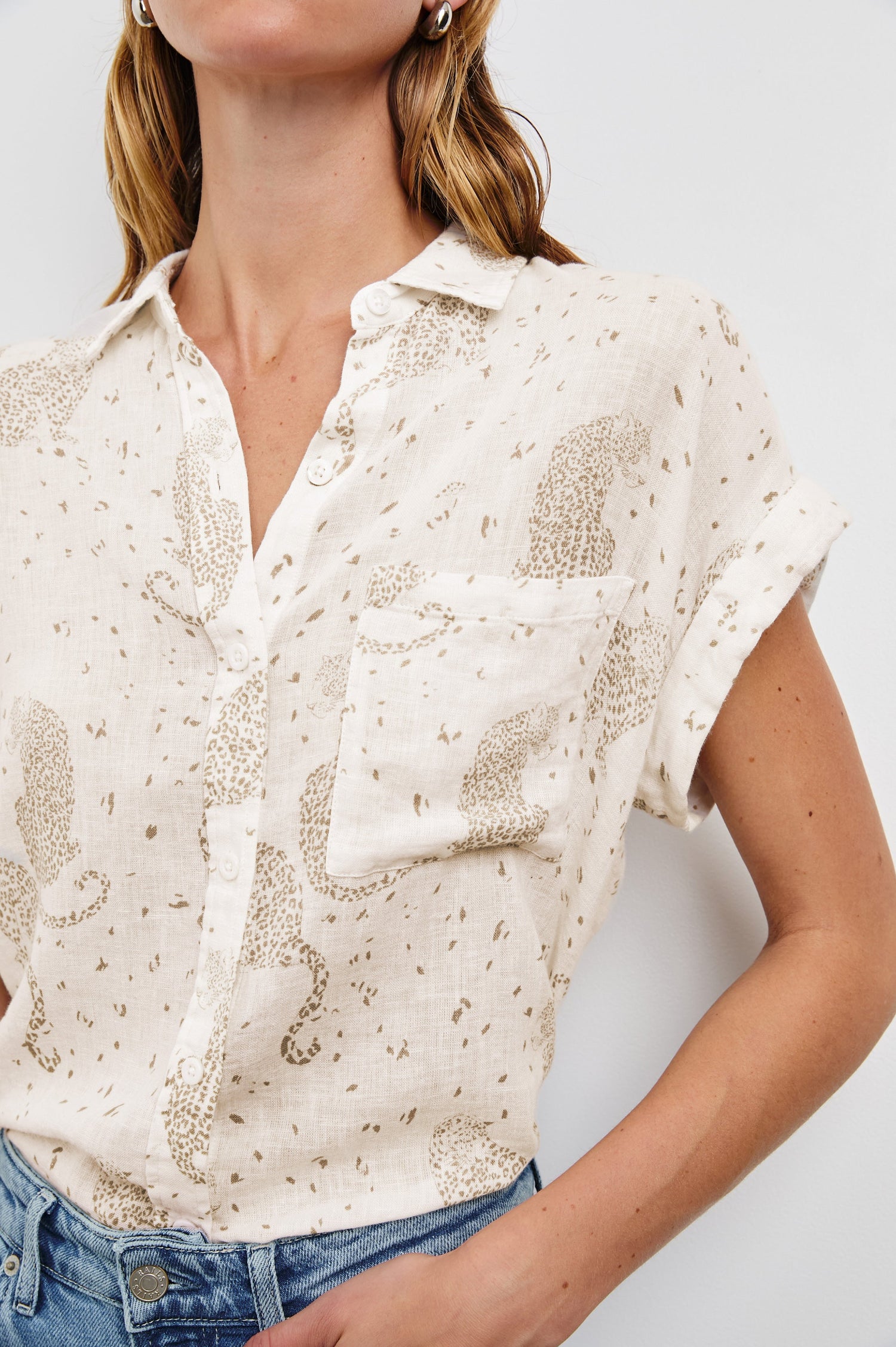 Whitney Short Rolled Sleeves Button Up with a Chest Patch Pocket and Short Side Slits in Cheetah Spots Colorway, with spots and cheetahs in brown on cream - Front Tucked View Featured on Model