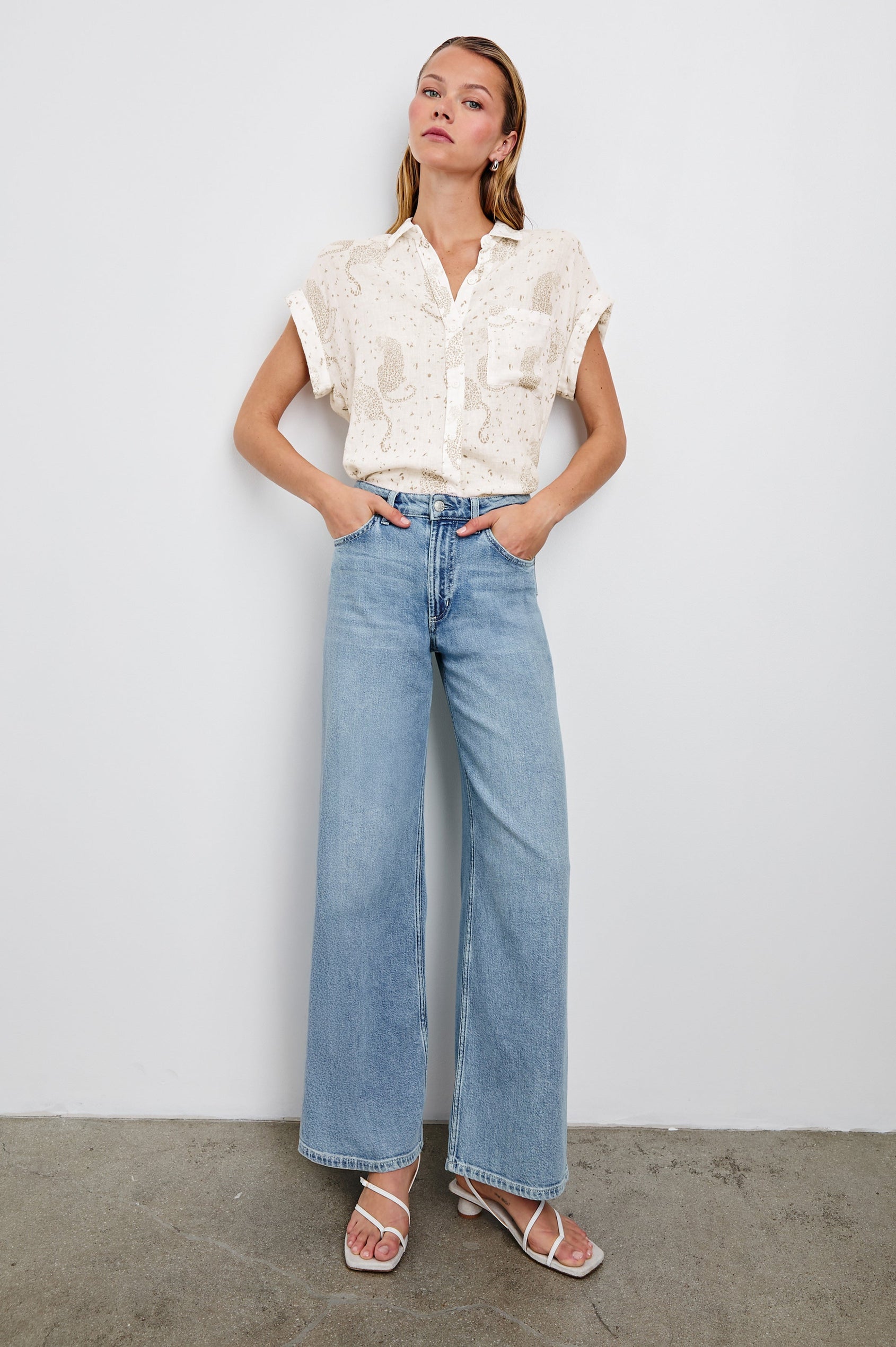 Whitney Short Rolled Sleeves Button Up with a Chest Patch Pocket and Short Side Slits in Cheetah Spots Colorway, with spots and cheetahs in brown on cream - Front Tucked Full Body View Featured on Model