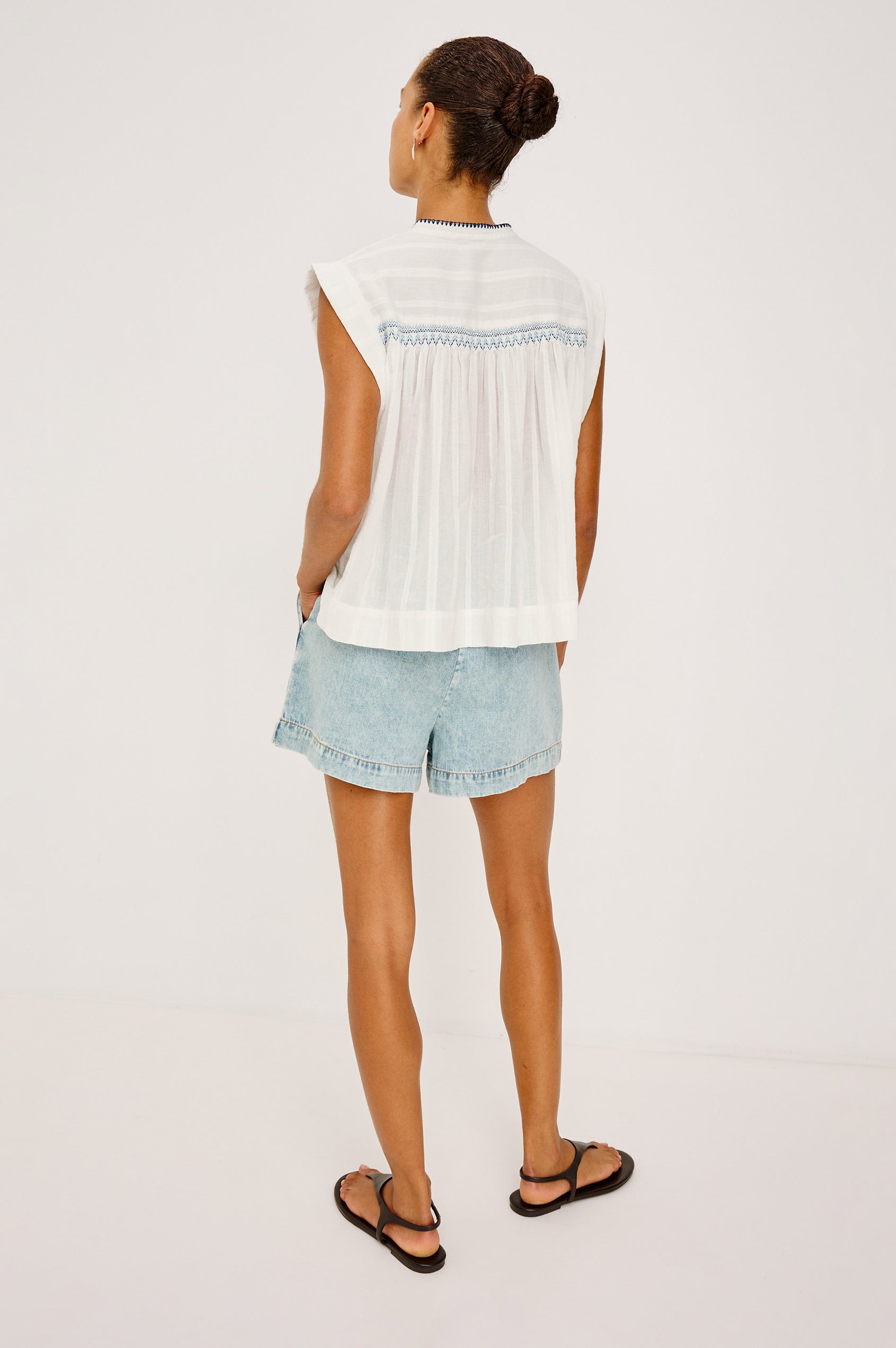 Willow Sleeveless Top in Cotton Voile With Diamond Pintucks at Front and Back Yokes, Rolled Arm Openings, Center Half Placket, and Loose Fit in White Colorway - Full Body Back View Featured on Model