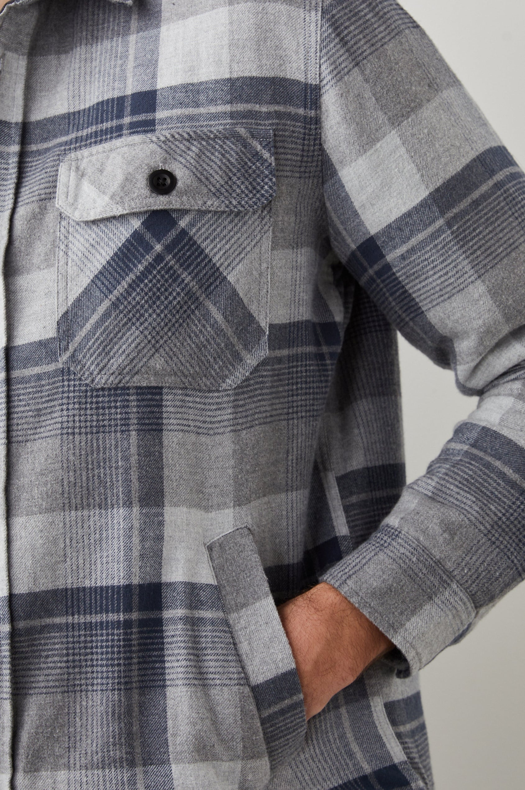 Worthing Jacket with Button Closure and two Chest Button Flap Pockets in Slate Mist Heather Colorway, a Grey and Blue Plaid - Front View Featured on Model