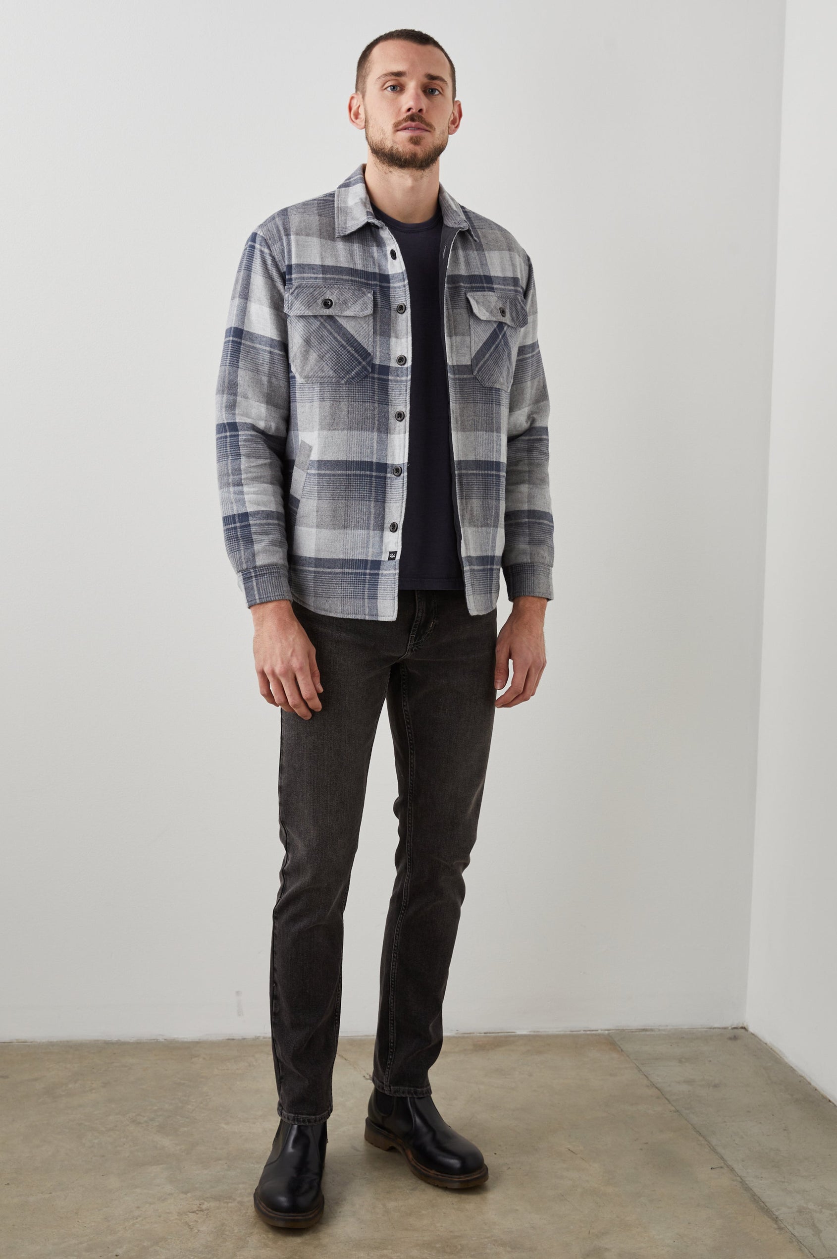 Worthing Jacket with Button Closure and two Chest Button Flap Pockets in Slate Mist Heather Colorway, a Grey and Blue Plaid - Front Full Body View Featured on Model