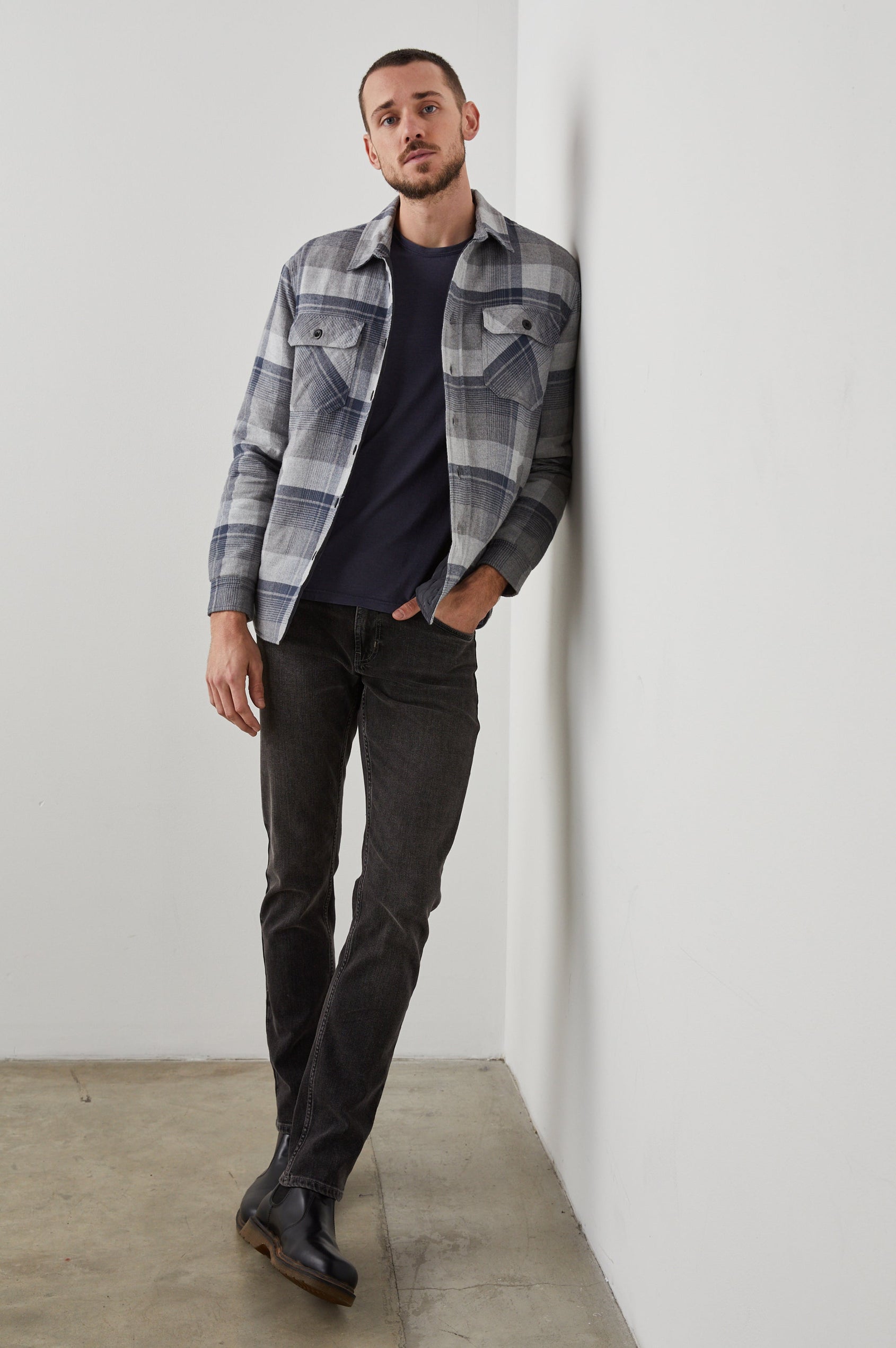 Worthing Jacket with Button Closure and two Chest Button Flap Pockets in Slate Mist Heather Colorway, a Grey and Blue Plaid - Front Full Body View Featured on Model