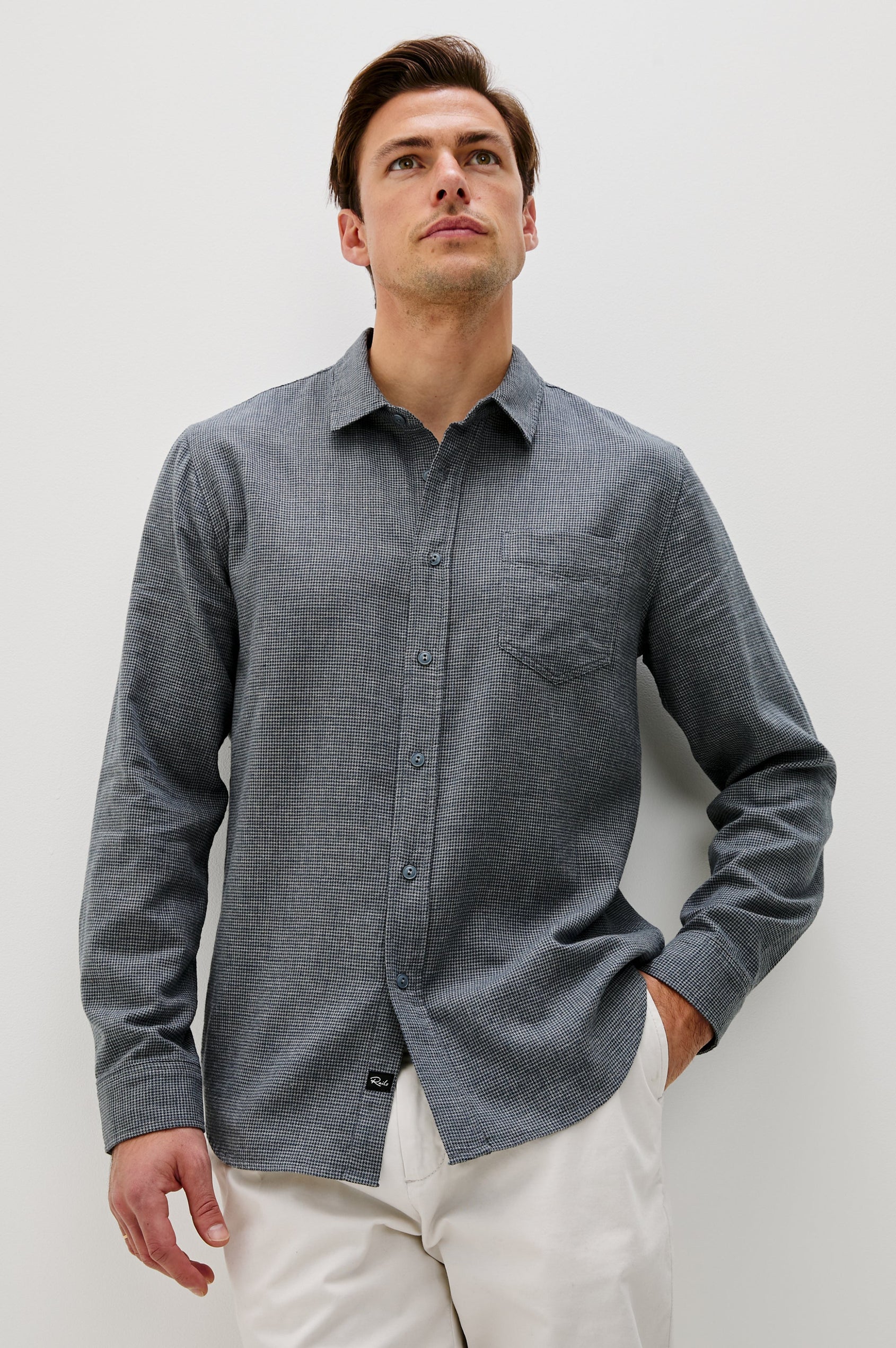 Wyatt Collared Button Front Shirt with Long Sleeves and a Chest Pocket in Charcoal Navy Houndstooth Colorway. Front View Shown on Model.