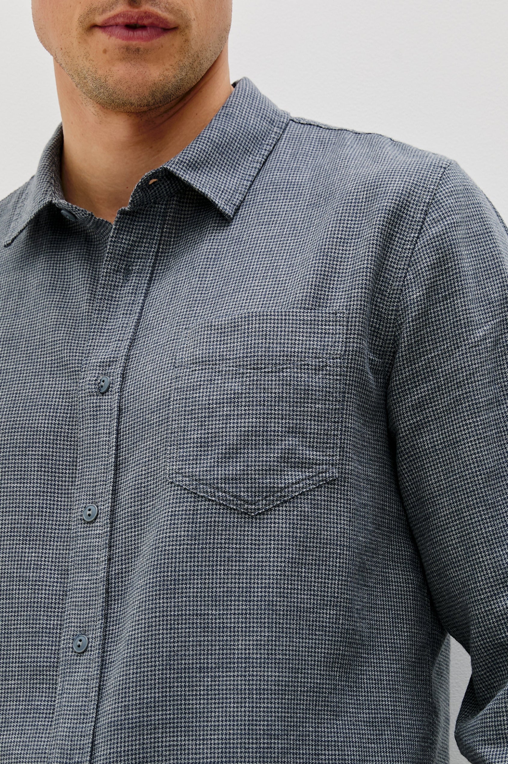 Wyatt Collared Button Front Shirt with Long Sleeves and a Chest Pocket in Charcoal Navy Houndstooth Colorway. Front Detailed View Shown on Model.