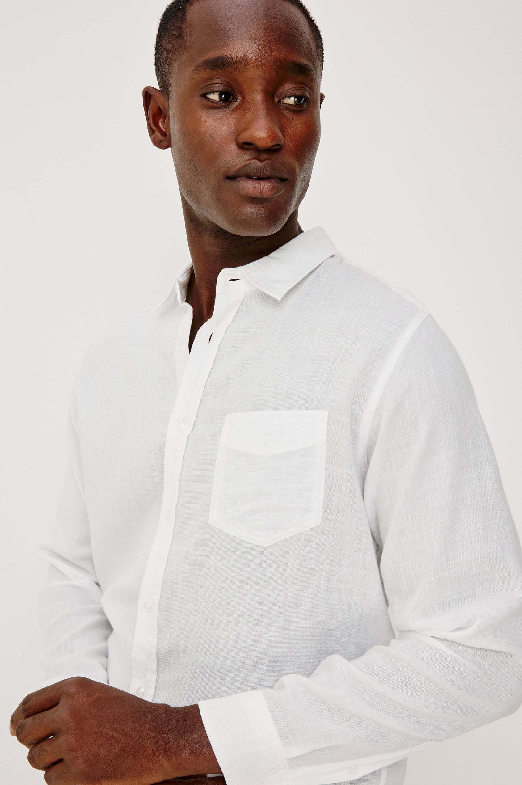 Wyatt Button Front Collared Shirt With Long Sleeves and Single Chest Pocket in White Colorway - Upper Body Front Close Up View Featured on Model