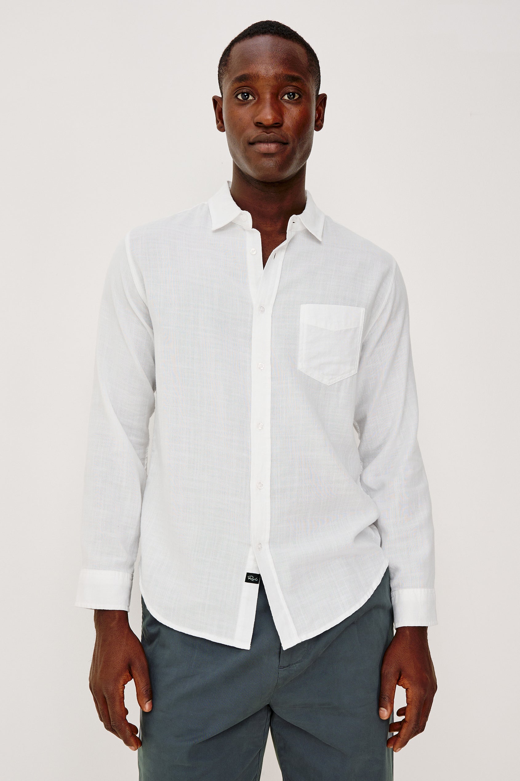 Wyatt Button Front Collared Shirt With Long Sleeves and Single Chest Pocket in White Colorway - Upper Body Front View Featured on Model