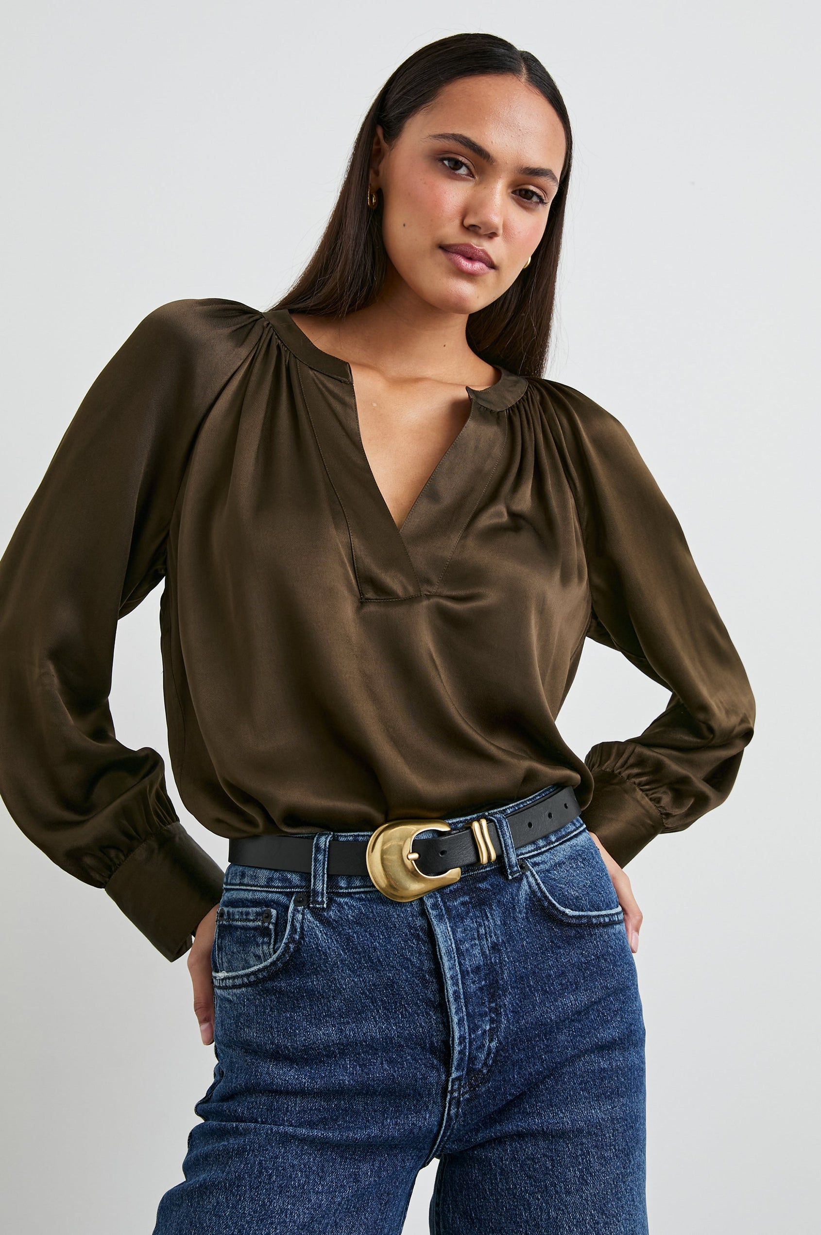 Wynna Long-Sleeve Top with a Deep V Neck and Ruching above the Cuffs and at the Neckline in Dark Moss Colorway - Front Tucked View Featured on Model
