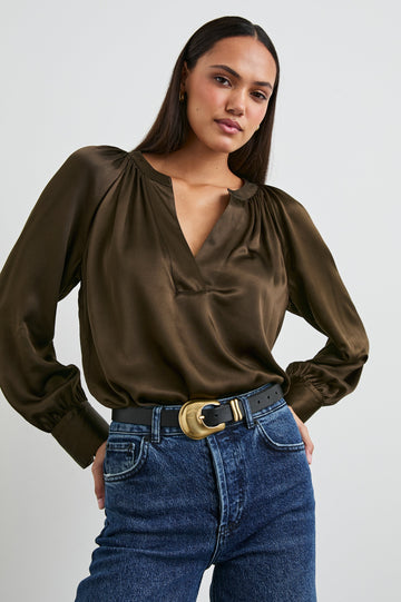 Wynna Long-Sleeve Top with a Deep V Neck and Ruching above the Cuffs and at the Neckline in Dark Moss Colorway - Front Tucked View Featured on Model