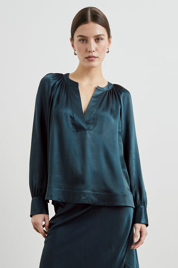 Wynna Long-Sleeve Top with a Deep V Neck and Ruching above the Cuffs and at the Neckline in Deep Sea Colorway - Front View Featured on Model