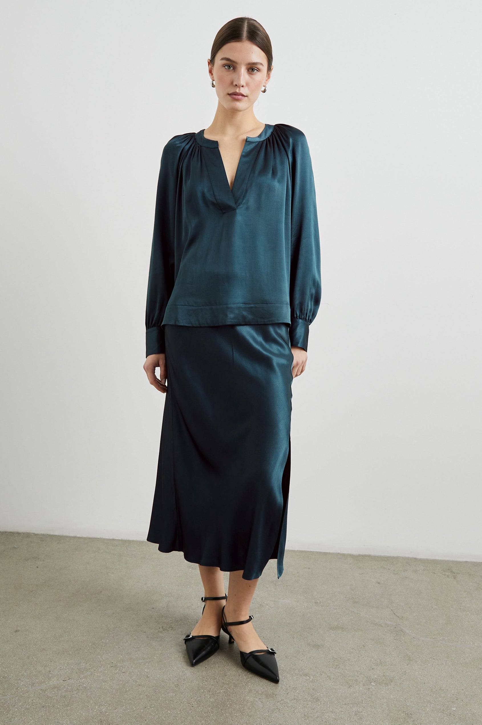 Wynna Long-Sleeve Top with a Deep V Neck and Ruching above the Cuffs and at the Neckline in Deep Sea Colorway - Front Full Body View Featured on Model