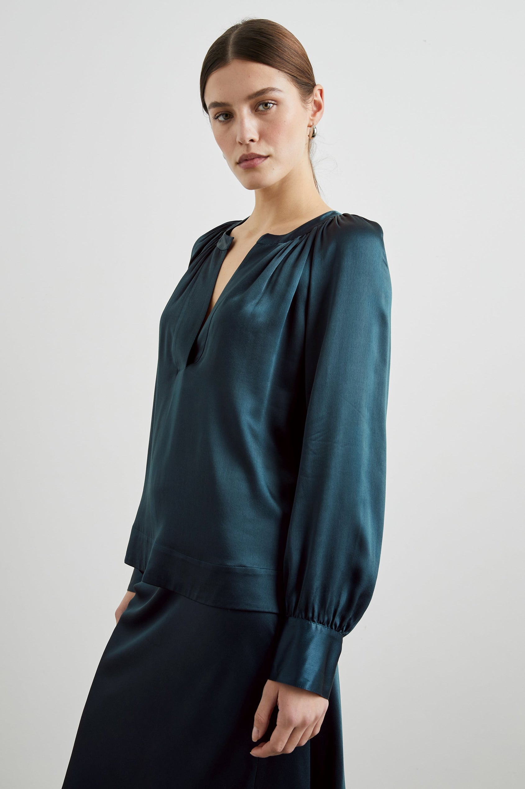 Wynna Long-Sleeve Top with a Deep V Neck and Ruching above the Cuffs and at the Neckline in Deep Sea Colorway - Front View Featured on Model