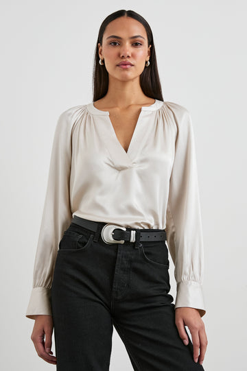 Wynna Long-Sleeve Top with a Deep V Neck and Ruching above the Cuffs and at the Neckline in Ivory Colorway - Front Tucked View Featured on Model