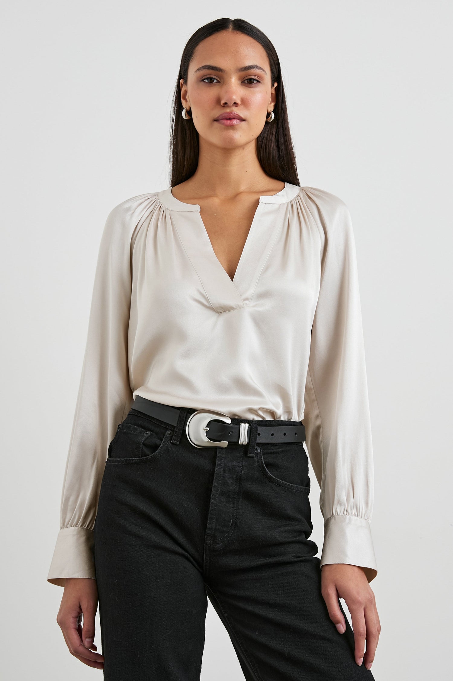 Wynna Long-Sleeve Top with a Deep V Neck and Ruching above the Cuffs and at the Neckline in Ivory Colorway - Front Tucked View Featured on Model