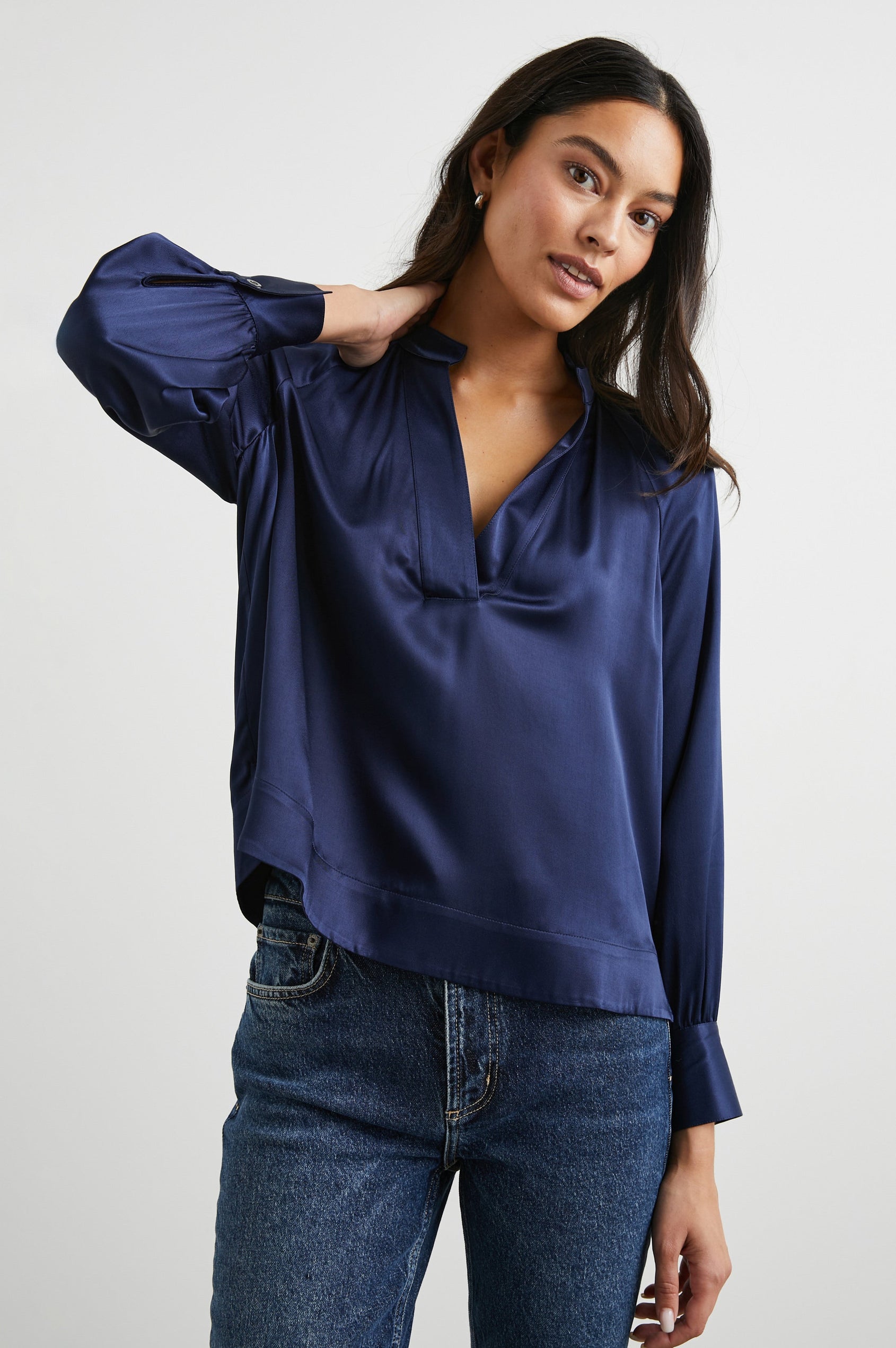 Wynna Long-Sleeve Top with a Deep V Neck and Ruching above the Cuffs and at the Neckline in Navy Colorway - Front View Featured on Model