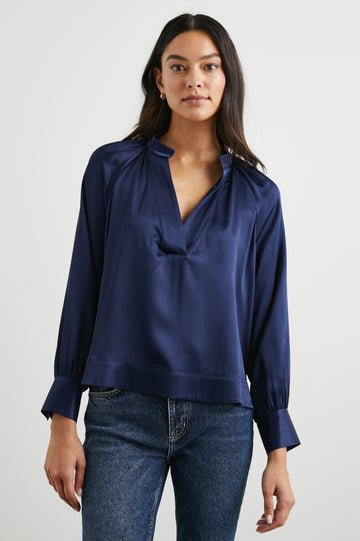 Wynna Long-Sleeve Top with a Deep V Neck and Ruching above the Cuffs and at the Neckline in Navy Colorway - Front View Featured on Model