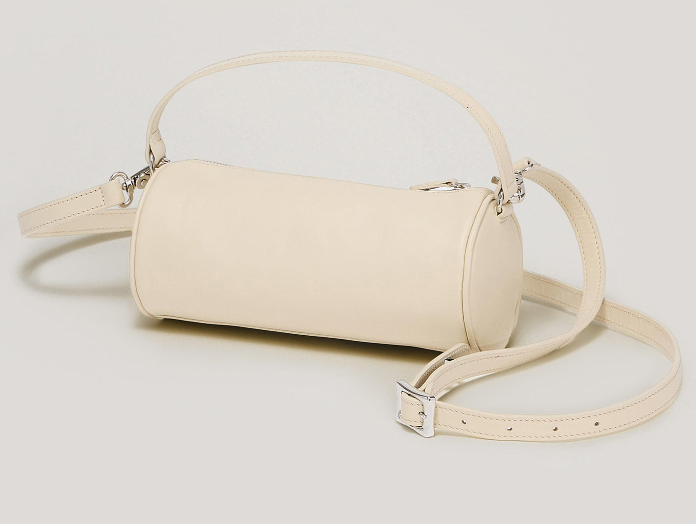 Beige handbag with a strap on a light gray background