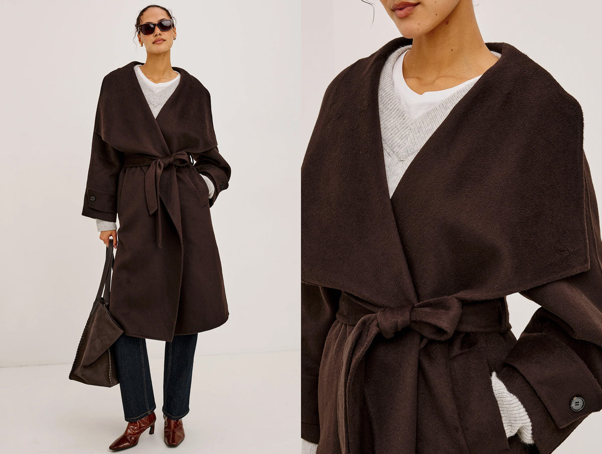 A dark brown wrap coat with a tie waist, shown on a model in a full-length view and a close-up view. The model is also wearing a white top, dark blue jeans, brown shoes, and holding a matching brown handbag.