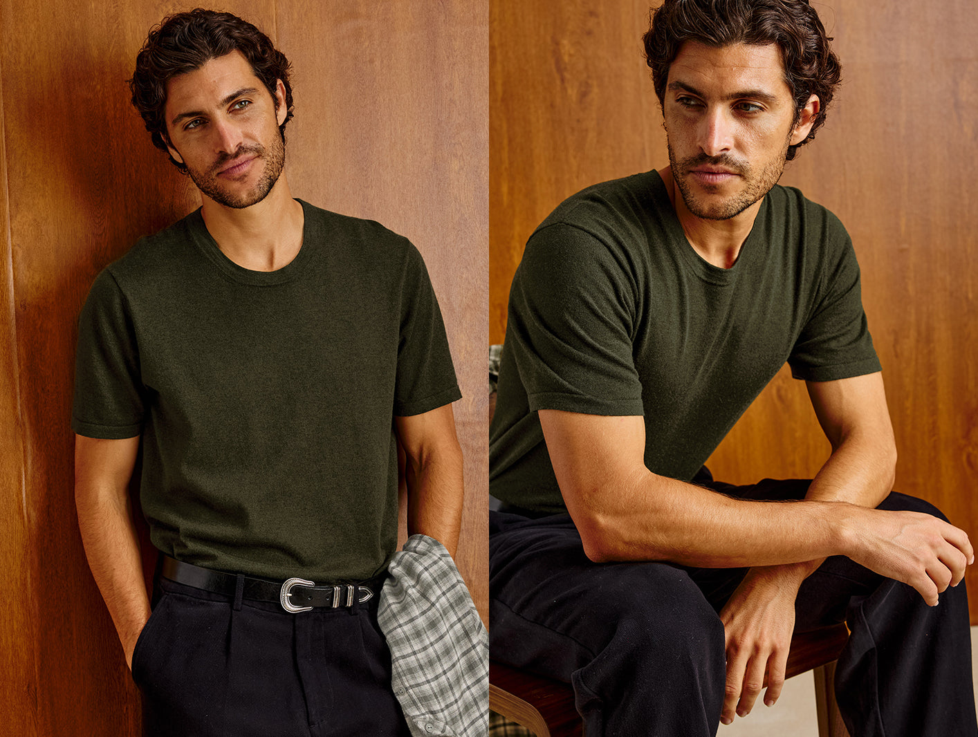 A man modeling an olive green short-sleeve crewneck t-shirt in a split-screen portrait, standing against a wood-paneled wall on the left and sitting on a stool on the right, wearing dark trousers and holding a plaid shirt.