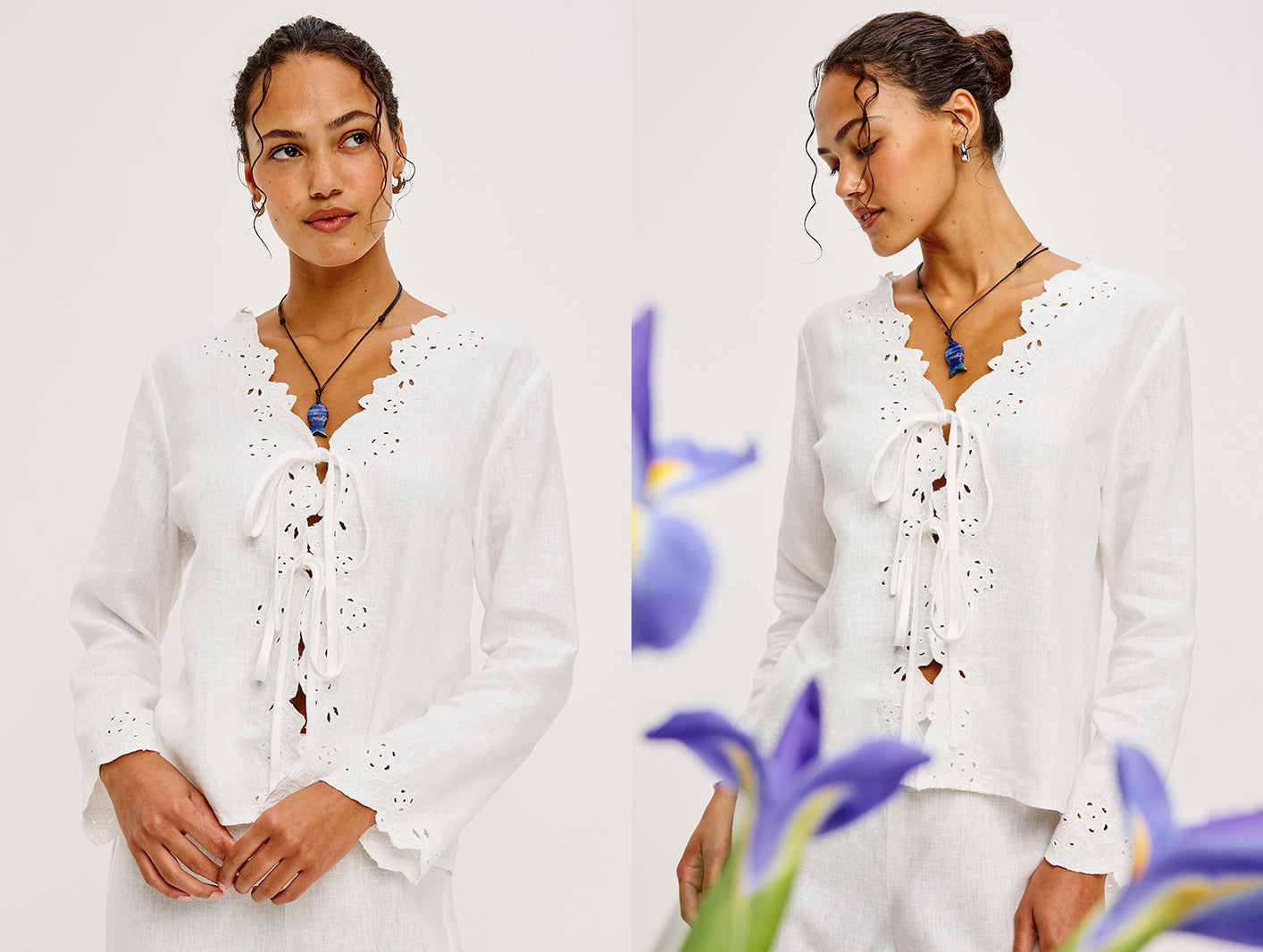 Woman wearing a white blouse with lace details against a white background